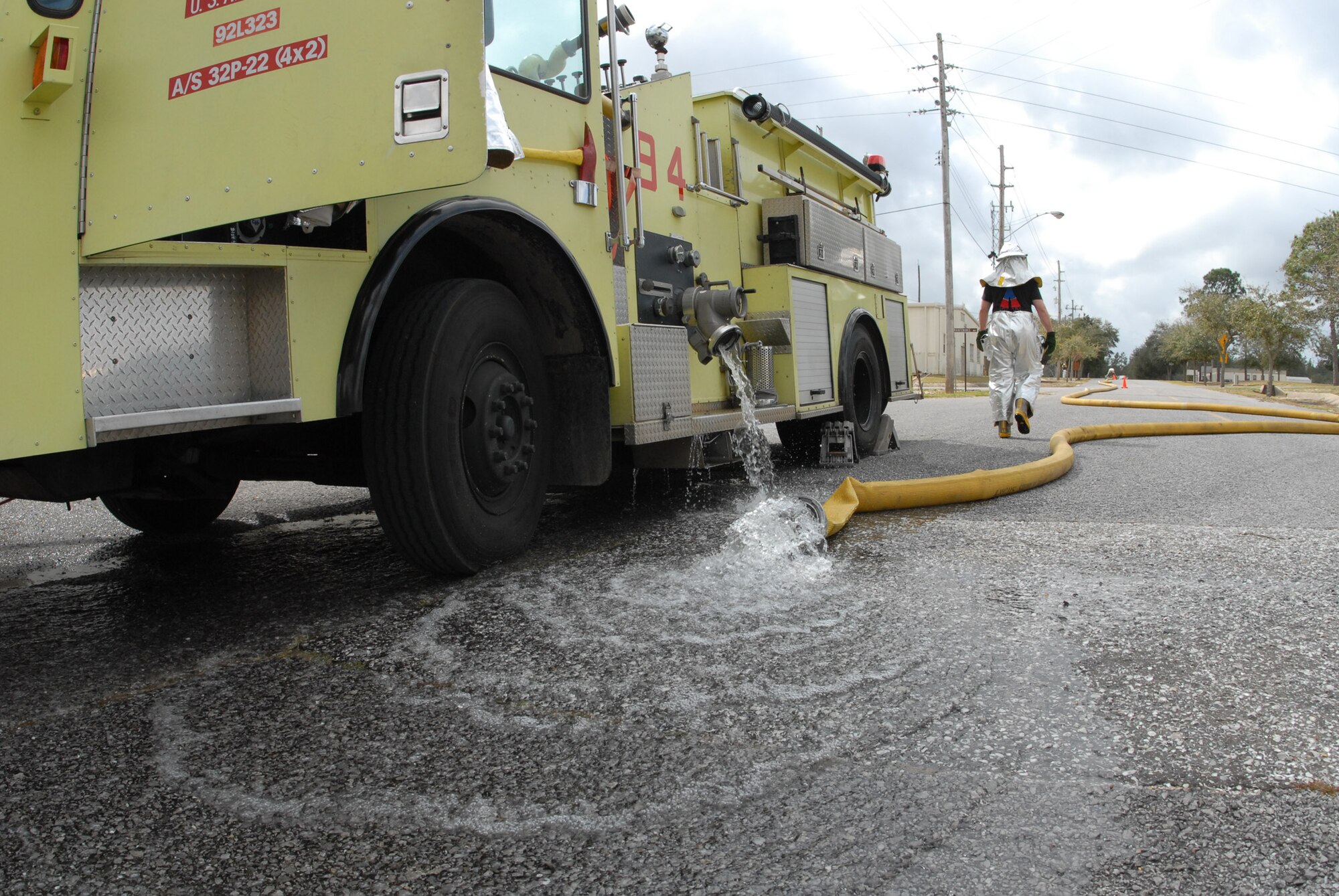 After unhooking the main hose from the fire engine, a firefighter from the 919th Civil Engineer Squadron walks toward the hydrant to break the connection after a simulated burning building exercise March 7 at Duke Field.  The exercise, performed as part of the Unit Compliance Inspection, had the firefighters secure the scene, put out the fire, evacuate victims and set up a triage.  The entire scenario lasted less than 15 minutes, with two teams entering the building and evacuating two simulated victims.  U.S. Air Force photo / Staff Sgt. Samuel King Jr.