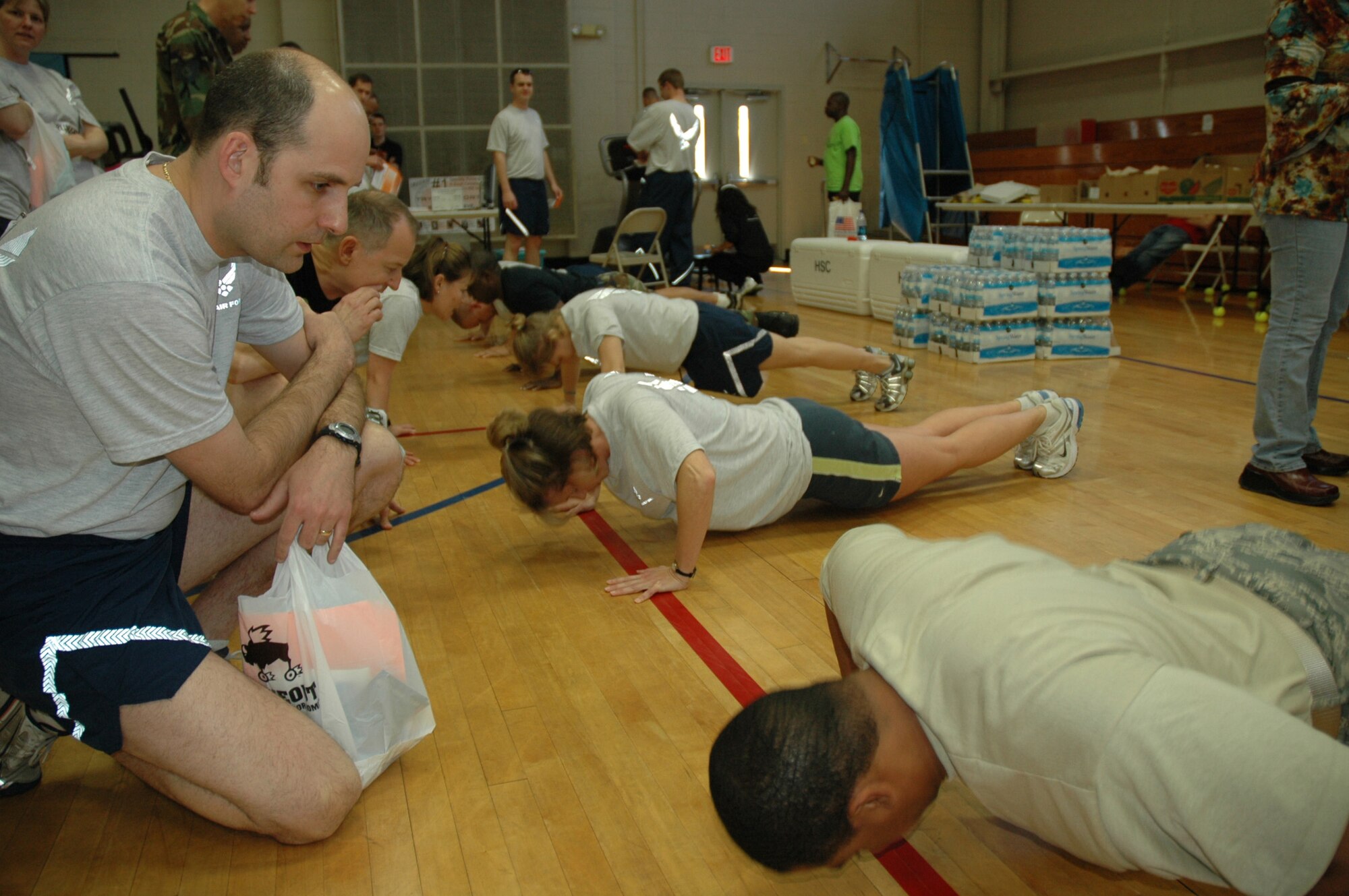 Members from across the 315th Airlift Wing participate in a first sergeants' pushup contest at the 2nd Annual Health and Wellness Fair here Saturday.  First Lieutenant Whitney Wingo and Staff Sgt. Brooks Boland, both from the 38th Aerial Port Squadron won the contest with 576 push-ups.
