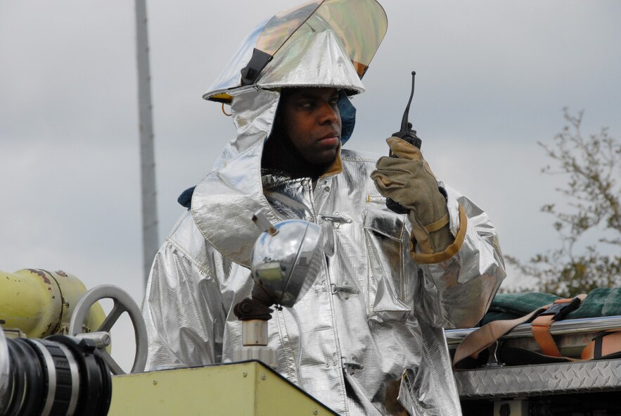 Staff Sgt. David Davis, a firefighter with the 919th Civil Engineer Squadron, monitors the scene of a simulated burning building from the top of one of the fire engines during a fire exercise March 7 at Duke Field.  The exercise, performed as part of the Unit Compliance Inspection, had the firefighters secure the scene, put out the fire, evacuate victims and set up a triage.  The entire scenario lasted less than 15 minutes, with two teams entering the building and evacuating two simulated victims.  U.S. Air Force photo / Staff Sgt. Samuel King Jr.