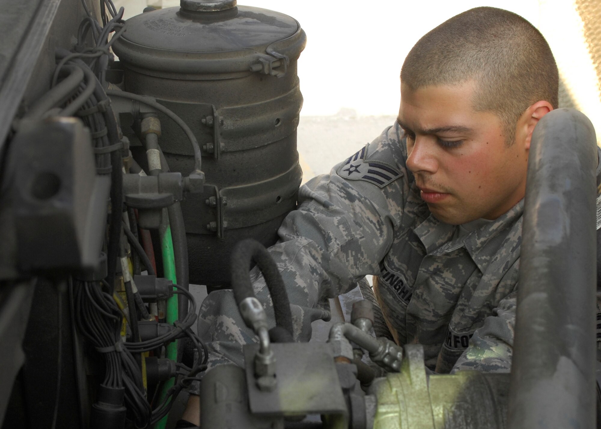 Senior Airman Michael Cottingham, 455th Expeditionary Logistics Readiness Squadron fixes an R-11 gas pedal at Bagram Air Field, Afghanistan, Mar. 3. The gas pedal had no pressure so the vehicle could not move, Airman Cottingham fixed the gas pedal on the  flightline, which allowed the mission to go on. Airman Cottingham is deployed from Yokota Air Base, Japan and hales from Grand Junction, Colo. (U.S. Air Force photo/ Senior Airman Erik Cardenas)(Released)