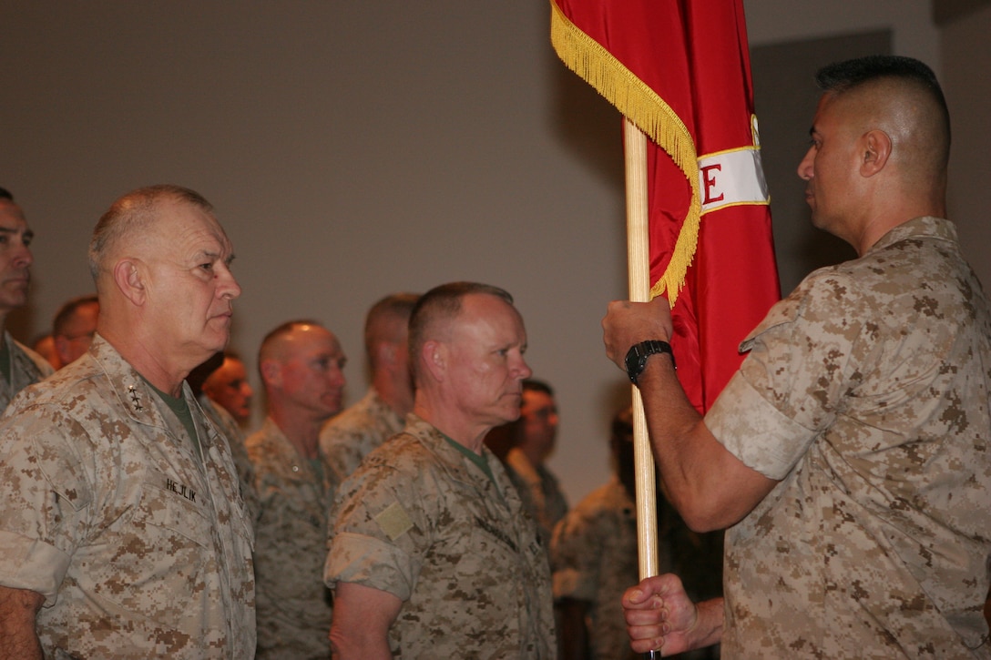 Sgt. Maj. Ernest Hoopii, 2nd Marine Expeditionary Brigade sergeant major, presents the 2nd MEB colors to Lt. Gen. Dennis J. Hejlik (left) during the brigade’s assumption of command ceremony March 9.   Brig. Gen. Larry Nicholson received the colors from Hejlik, symbolizing the authority and accountability of command vested in Nicholson by naming him the 2nd MEB commanding general.