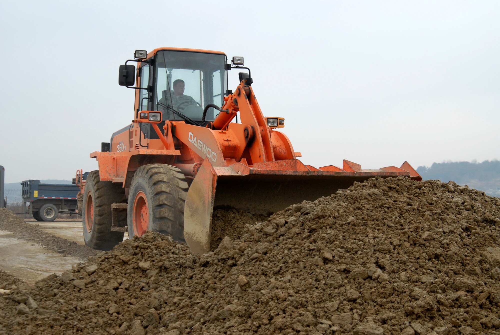Staff Sgt. Gary Cochran, 8th Civil Engineer Squadron, clears dirt from around a crater during an Airfield Damage Repair exercise at Kunsan Air Base, Republic of Korea, March 5, 2009. ADR is a temporary fix on damage caused to the airfield by enemy fire to allow aircraft to quickly get back in the air. (U.S. Air Force Photo by SSgt Jason Colbert)