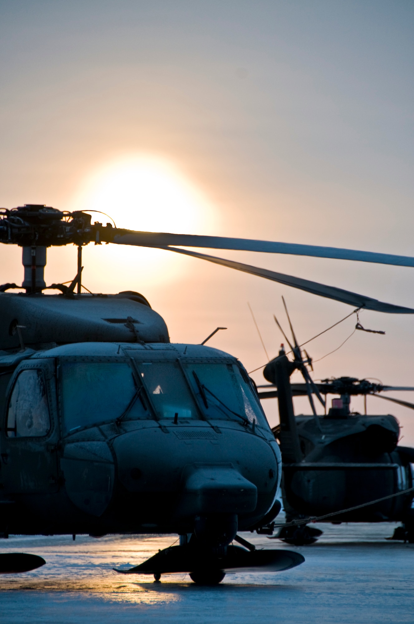 Two Black Hawk helicopters sit on a frozen flight line at Army Aviation Operating Facility No. 2 in Bethel, Alaska, as pilots prepare to transport two veterinary teams to remote villages in the western part of the state March 7, 2009. Operation Arctic Care is a joint military medical readiness exercise that brings no-cost health care to underserved Alaskan residents, including dental, optometry and veterinary support. This year's Navy-led mission has teams in 11 villages in Western Alaska's Yukon-Kuskokwim Delta region. (U.S. Air Force photo by Senior Airman Christopher Griffin)(Released)