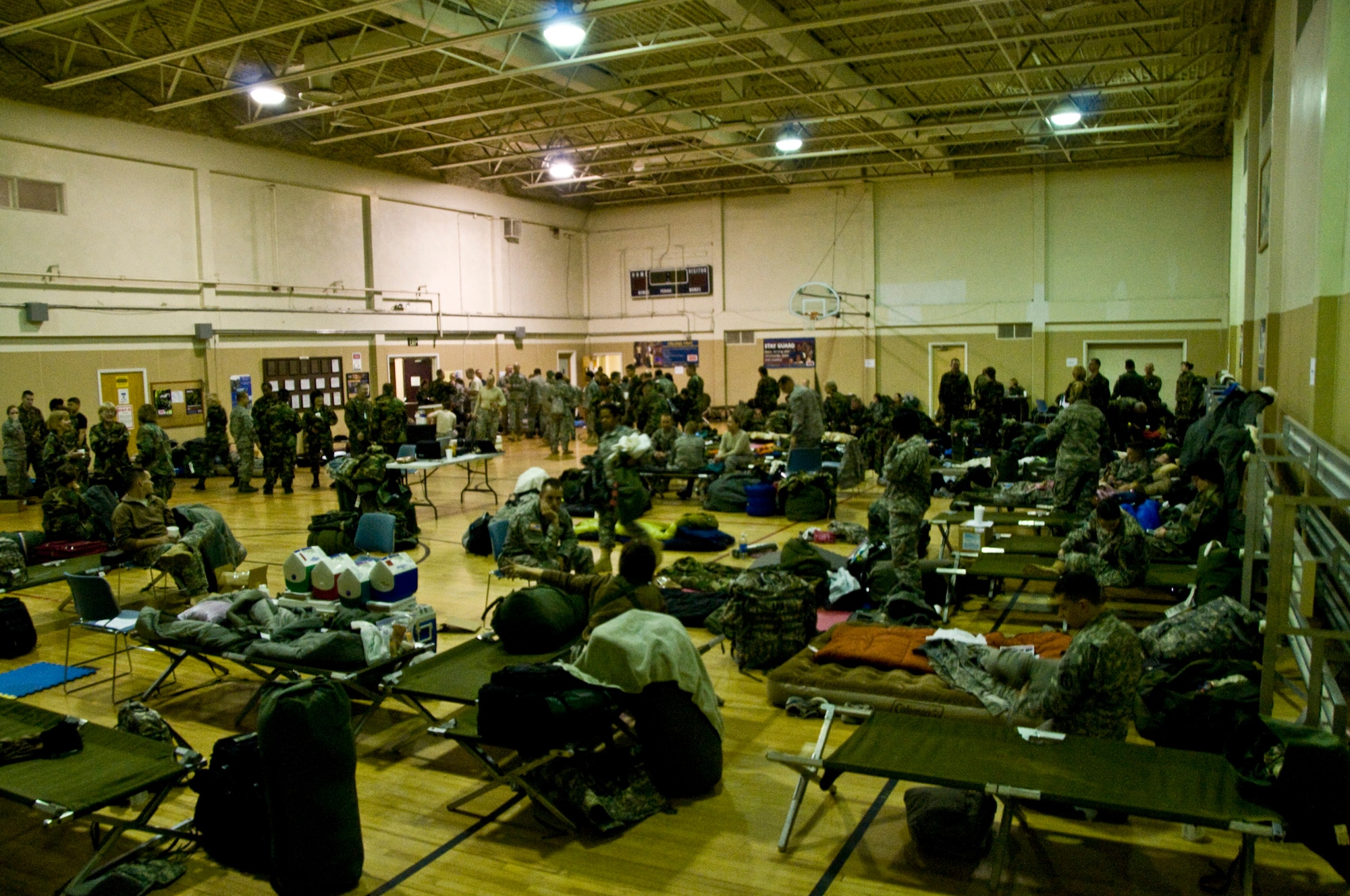 Airmen, sailors, soldiers and Marines fill the gymnasium of the Alaska Army National Guard Armory in Bethel, Alaska, in preparation to deploy in support of the 15th annual Operation Arctic Care. A joint military medical readiness exercise, Arctic Care provides no-cost health care to underserved Alaskan residents, including dental, optometry and veterinary support. This year's Navy-led mission has teams in 11 villages in Alaska's Yukon-Kuskokwim Delta region.(U.S. Air Force photo by Senior Airman Christopher Griffin)(RELEASED)