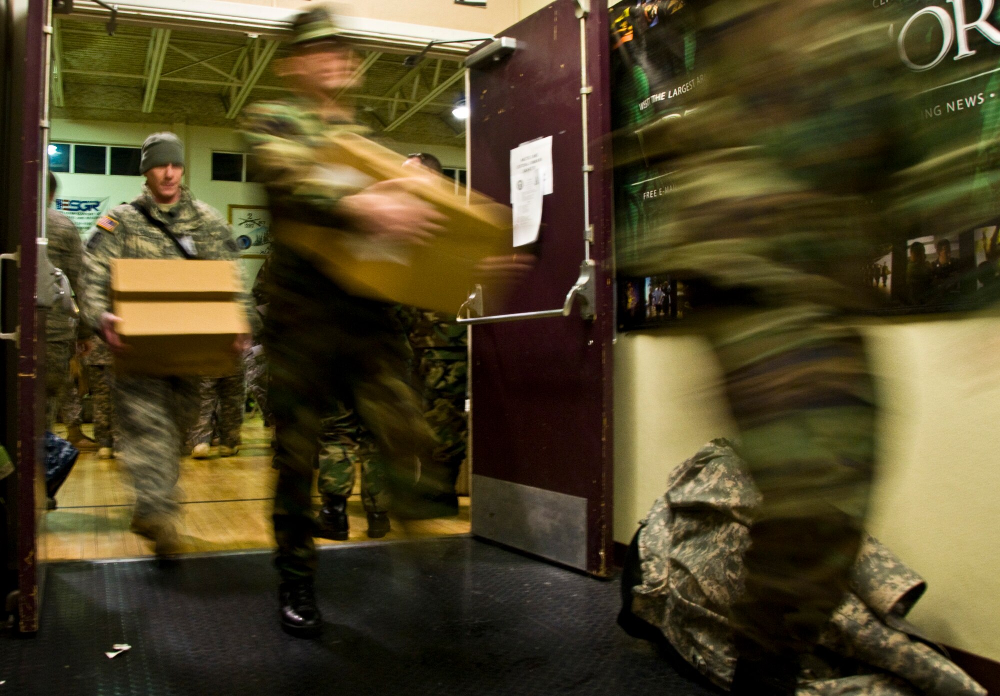 Sailors and soldiers carry medical supplies from the gymnasium of the Alaska Army National Guard Armory in Bethel, Alaska, in preparation to deploy in support of the 15th annual Operation Arctic Care.Operation Arctic Care is a joint military medical readiness exercise that brings no-cost health care to underserved Alaskan residents, including dental, optometry and veterinary support. This year's Navy-led mission has teams in 11 villages in Alaska's Yukon-Kuskokwim Delta region.(U.S. Air Force photo by Senior Airman Christopher Griffin)