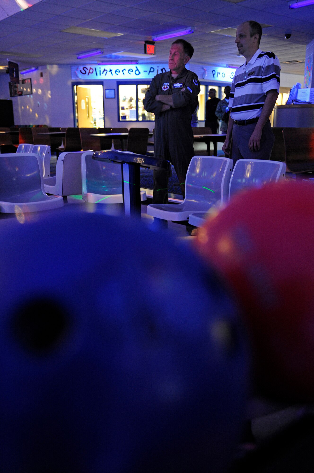 (Right) Kenneth Young, Ellsworth Bowling Center manager, demonstrates the cosmic bowling lighting system to Lt. Gen. Norman Seip, 12th Air Force commander, during a visit, March 4. Cosmic bowling is available on Saturday nights. (U.S. Air Force photo/Senior Airman Marc I. Lane)