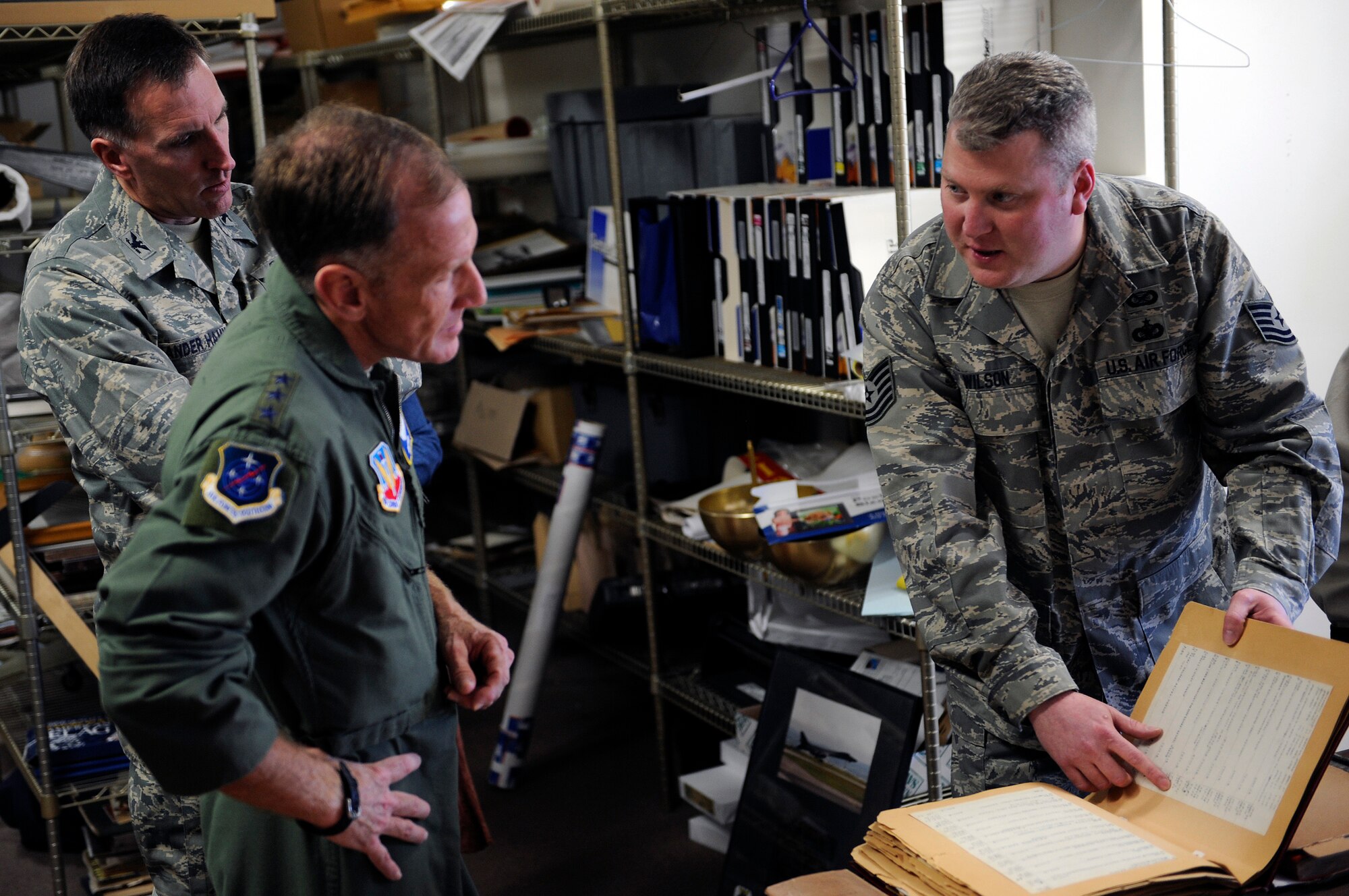 (From right) Tech. Sgt. Steven Wilson, South Dakota Air and Space Museum director, shows World War II flight logs to Lt. Gen. Norman Seip, 12th Air Force commander, and Col. Scott Vander Hamm, 28th Bomb Wing commander, at the SDASM, March 4. The flight logs show documented proof of close air support missions during WWII. (U.S. Air Force photo/Senior Airman Marc I. Lane)