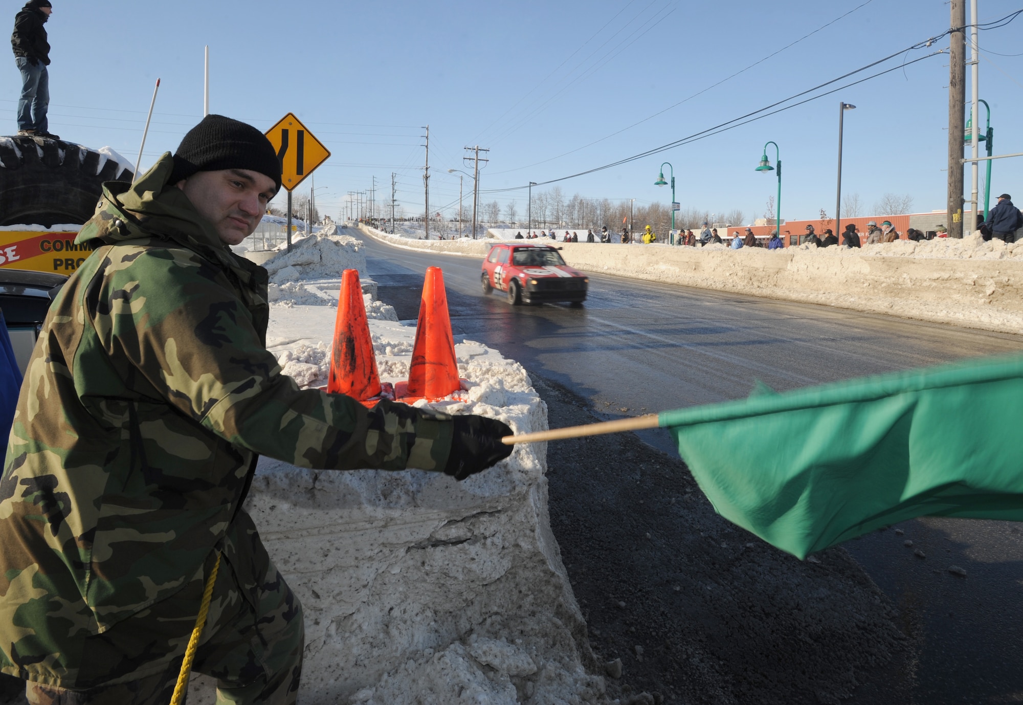 ANCHORAGE, Alaska -- Tech. Sgt. Mike Rogers, 3rd Communications Squadron, waves the green flag during the Grand Prix. Held in conjunction with the annual Anchorage Fur Rendezvous Winter Carnival, the Anchorage Fur Rondy Grand Prix has been the premier event of the Alaska Sports Car Club for 33 years, according to the club's Web site. (U.S. Air Force photo/Senior Airman Matt Owens)