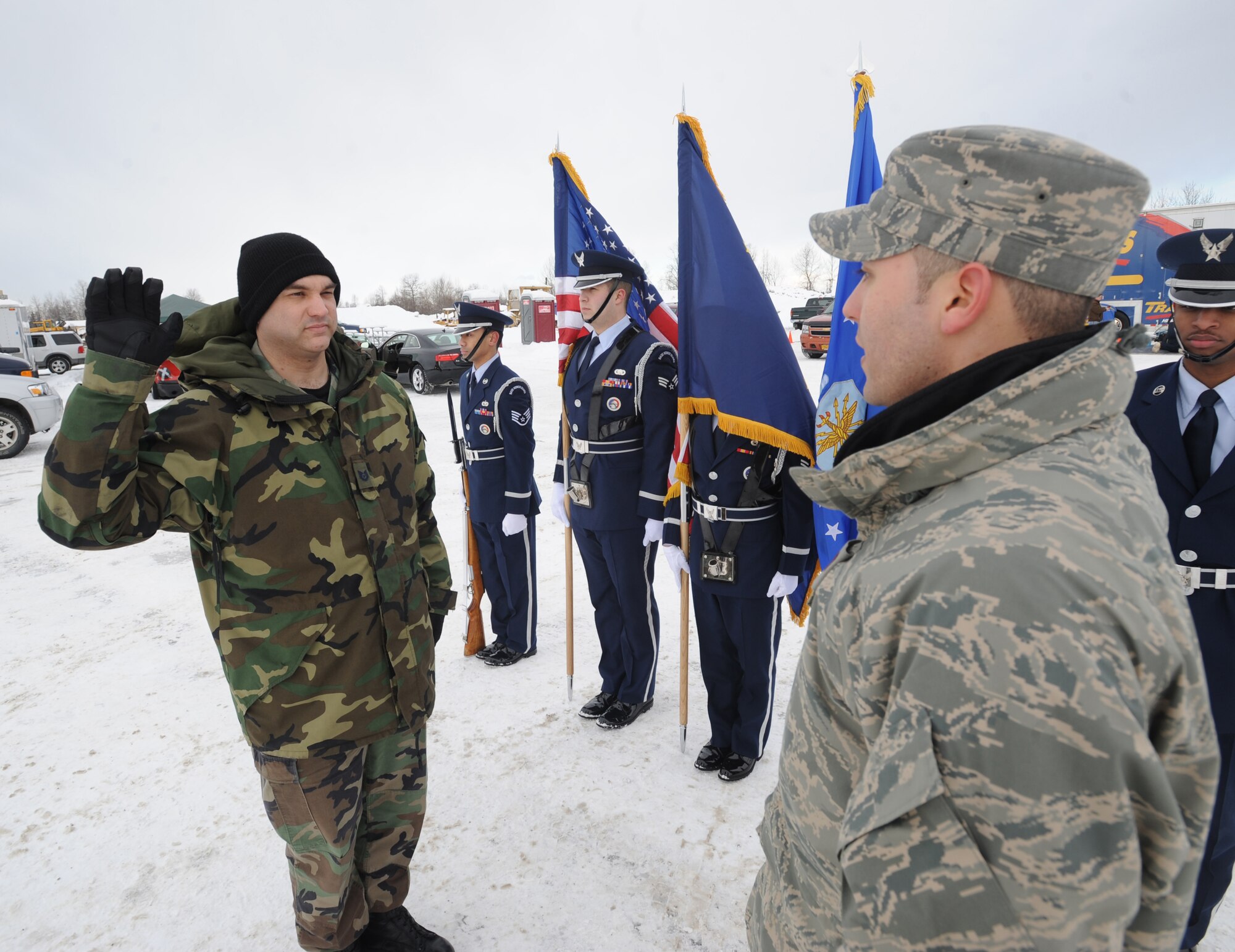 ANCHORAGE, Alaska -- Second Lt. Juan Pizarro, 732nd Air Mobility Squadron, re-enlists Tech. Sgt. Mike Rogers, 3rd  Communications Squadron, for another five and a half years before the start of the Fur Rondy Grand Prix March 6, 2009. Rogers, who hails from Murfreesboro, Tenn., has been in the Air Force 15 years. He is the first person to re-enlist at the Grand Prix. (U.S. Air Force photo/Senior Airman Matt Owens)

