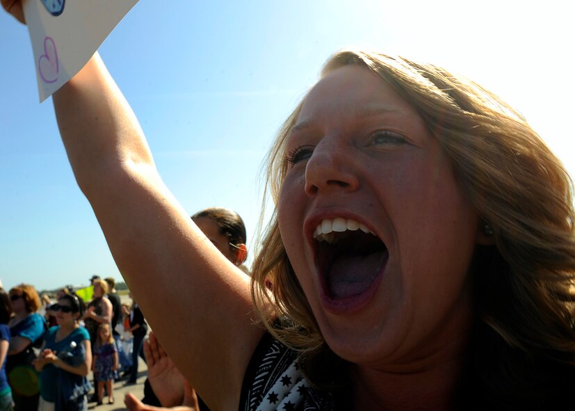 MOODY AIR FORCE BASE, Ga. -- Senior Airman Gina Chiaverotti, a member of the 23rd Wing public affairs office, yells in excitement as the Airmen from the 75th Aircraft Maintenance Unit return from a six month deployment here March 9. Members from the 75th AMU were stationed at Bagram Air Base, Afghanistan, in support of Operation Enduring Freedom. (U.S. Air Force photo by Senior Airman Brittany Barker)