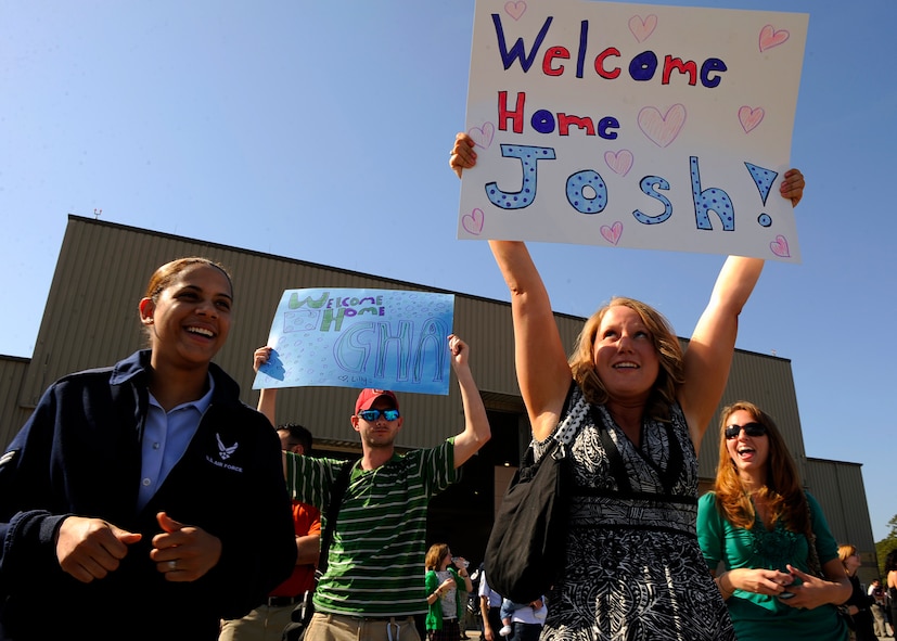 MOODY AIR FORCE BASE, Ga. -- Senior Airman Gina Chiaverotti, a member of the 23rd Wing public affairs office, proudly displays a decorated she made for the Airmen from the 75th Aircraft Maintenance Unit returning from a six month deployment here March. 9. The 75th AMU was deployed to Bagram Air Base, Afghanistan, in support of Operation Enduring Freedom. (U.S. Air Force photo by Senior Airman Brittany Barker)
