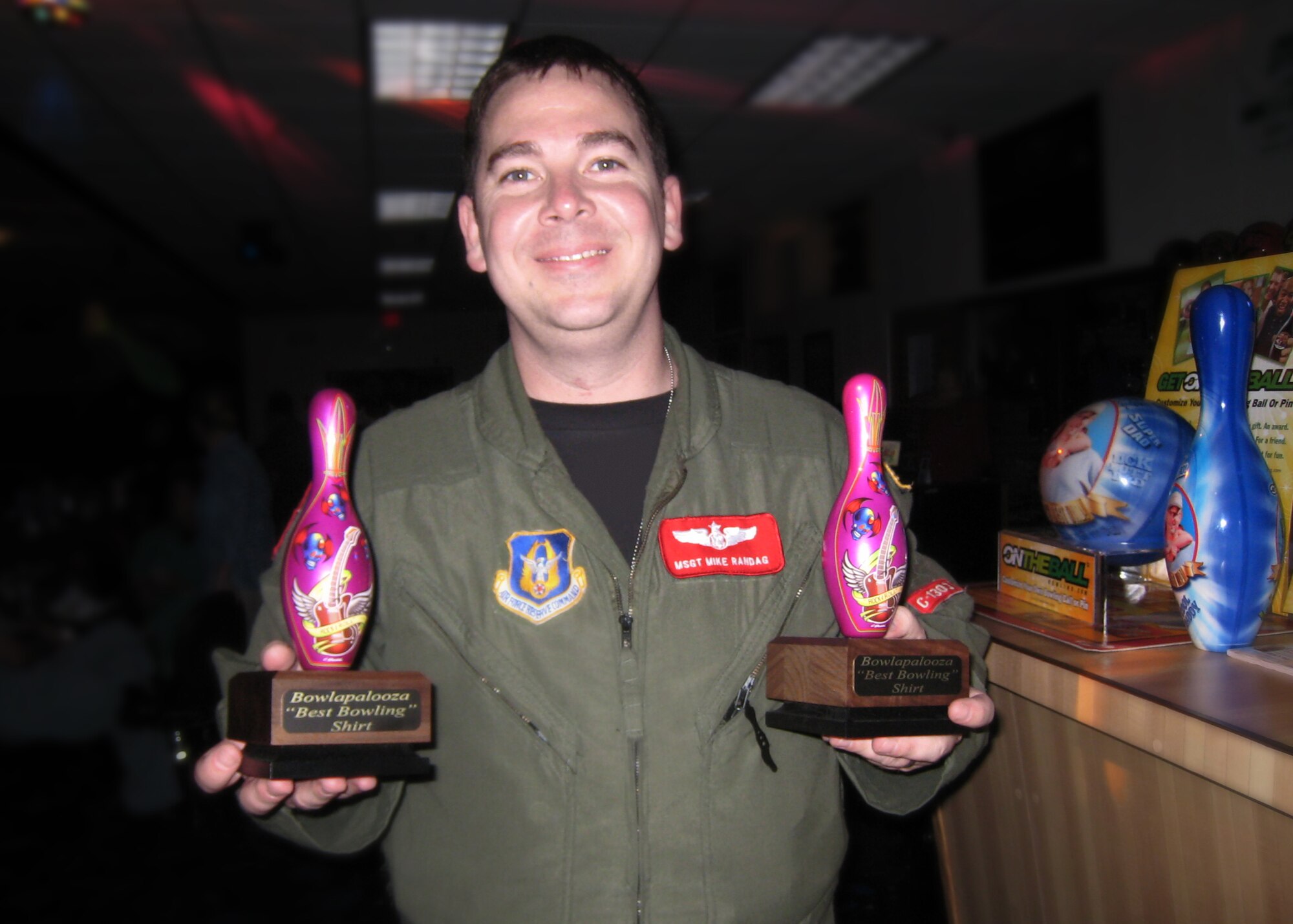 Master Sgt. Mike Randag, 815th Airlift Squadron loadmaster, prepares to award one of the many prizes that were handed out at the 2nd Annual Bowlapalooza tournament, held March 7 at Gaude Lanes bowling alley. The tournament gives reservists an opportunity to relax and enjoy fun with friends and family after a long day on a drill weekend. Proceeds from the event go toward supporting future unit morale events.