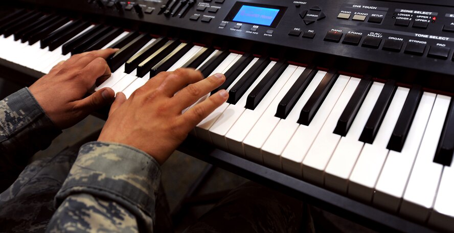 MOODY AIR FORCE BASE, Ga. -- Senior Airman James Ryan, 723rd Aircraft Maintenance Squadron aircraft maintenance apprentice, plays a song on a keyboard during the National Prayer Luncheon held at the Moody Field Club here March 5. (U.S. Air Force photo by Airman Joshua Green)  