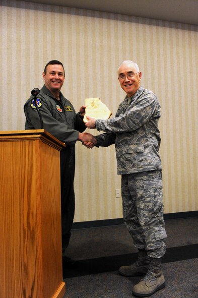MOODY AIR FORCE BASE, Ga. -- Col. Henry Santicola, 23rd Wing vice commander, presents a gift of appreciation to Col. Bobby Page, Air Combat Command command chaplain, and thanks him for presiding as the National Prayer Luncheon guest speaker here March 5. (U.S. Air Force photo by Airman Joshua Green)