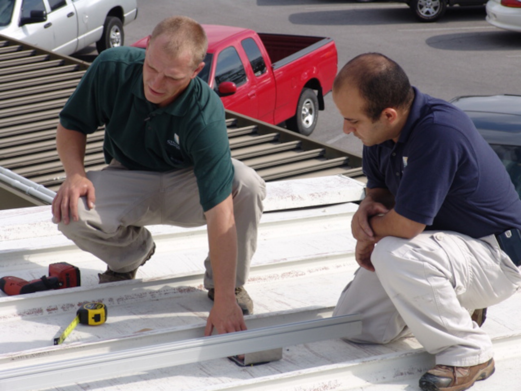 EGLIN AIR FORCE BASE, Fla. -- A crew from Standard Renewable Energy lays out a grid for solar panels on top of the 46th Aircraft Maintenance Squadron's Hangar 102.  Once fully operational, the 10 panels are expected to generate 50 percent of the hangar's power and save nearly 70,000 killowatts of electricity over the panels' 30-year lifespan. The AMXS effort is part of the Department of Defense's goals to reduce energy consumption 20 percent by 2015. (USAF photo/Airman Christopher Jacobs)


