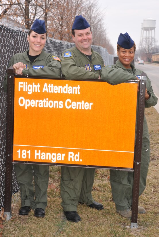 Scott AFB, IL--73rd Airlift Squadron flight attendants Tech. Sergeant Ariel Rodriquez, Senior Master Sgt. Jim Gallagher and Tech. Sgt. Viveka Ferrell stand proudly in front of the new sign outside their facility.  Read more about the 932nd Airlift Wing's flight attendants and their new flight kitchen in the March Gateway Wing.  (U.S. Air Force photo/Tech. Sgt. Gerald Sonnenberg.) 