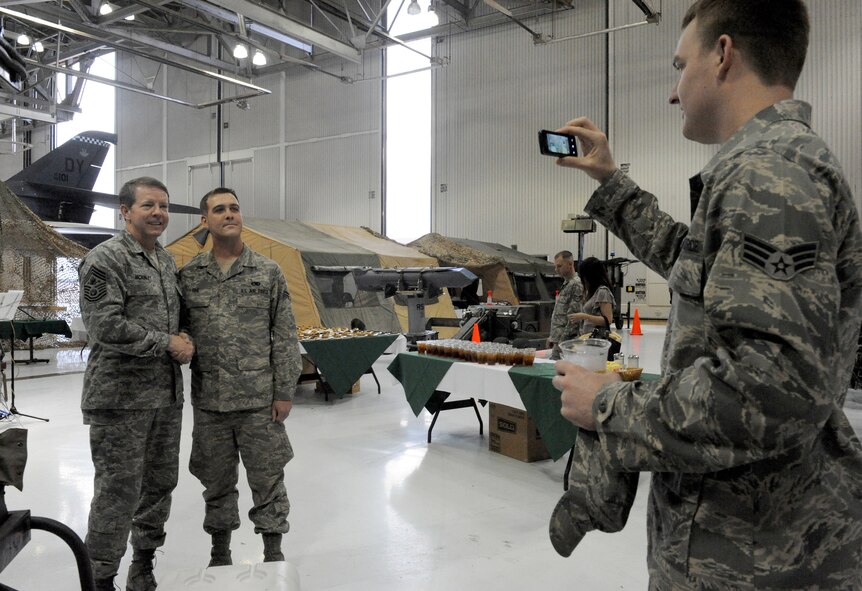 DYESS AIR FORCE BASE, Texas -- Chief Master Sgt. of the Air Force Rodney McKinley poses for a photo with Airman 1st Class Jason Fox, from the 7th Component Maintenance Squadron, during the 7th Maintence Group Maintence Professional of the Year banquet here, March 6.  Chief McKinley was the guest speaker for the event during his visit to Dyess AFB March 5-7.  (U.S. Air Force photo by Senior Airman Domonique Simmons)