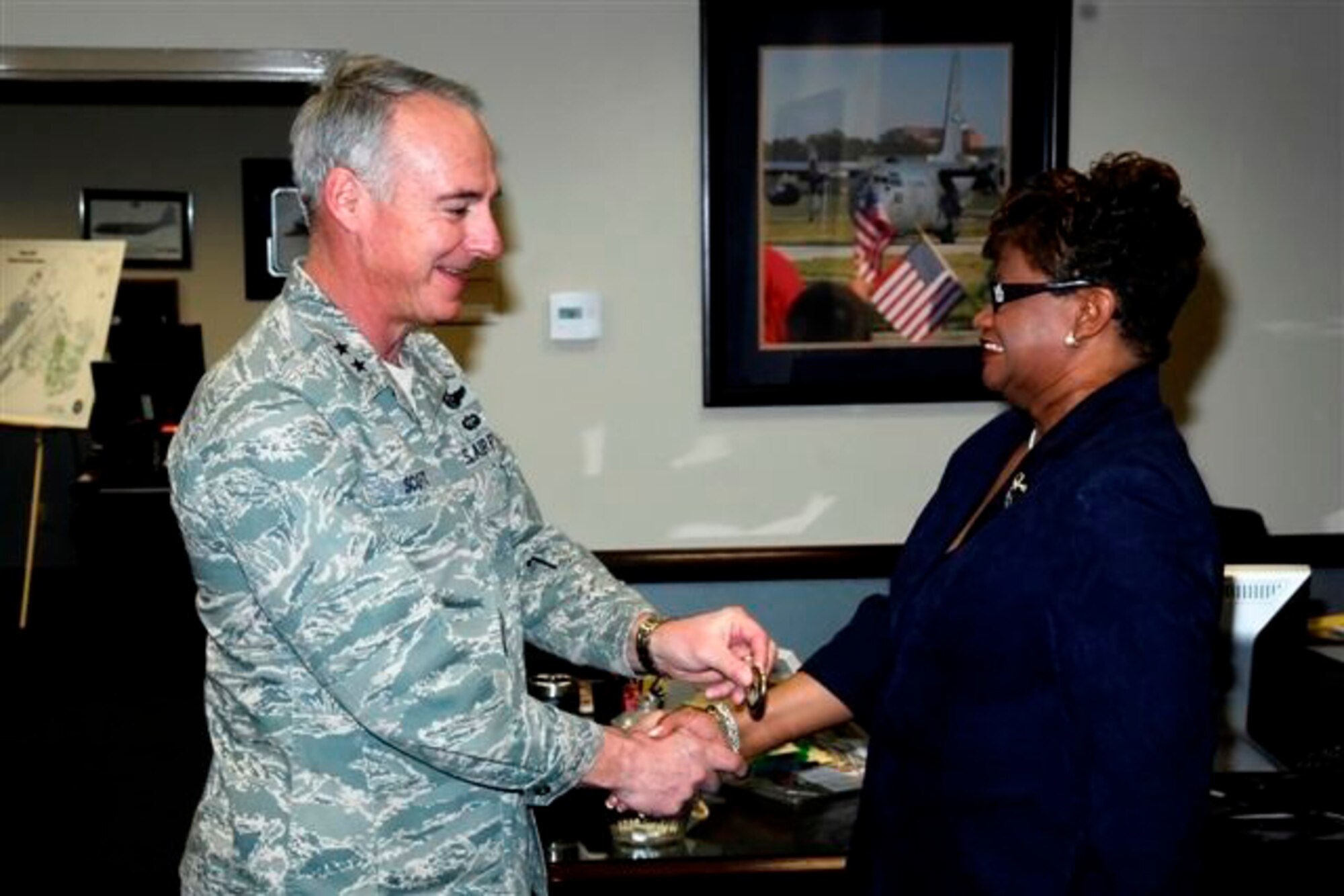 Gen. Winfield Scott III, 18th Air Force Commander, presents a coin to Ms. Hermean Yeadon, 43rd Mission Support Group secretary, commemorating her 30th year of civil service March 3. General Scott visited Pope to have an up-close look at the most recent Joint Forcible Entry Exercise, which concluded March 6 and brought together units from throughout AMC, including 3rd APS, and Army units for joint airdrop and other mission training. (U.S. Air Force Photo by Mike Murchison)