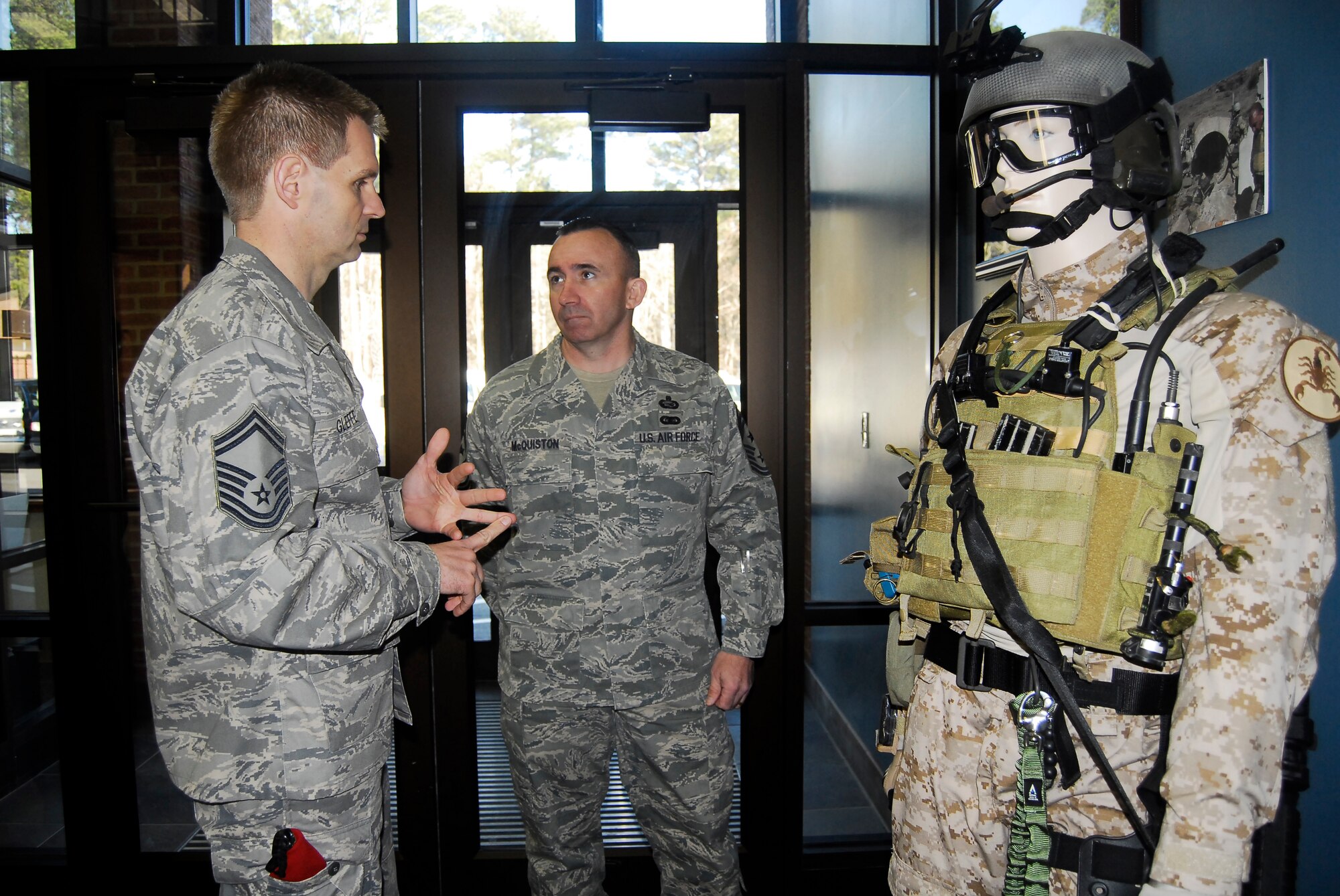 Chief Master Sgt. Ken McQuiston, U.S. Transportation Command Command Chief, listens as Senior Master Sgt. Sean Gleffe, Combat Control School commandant, explains an exhibit at the CCTS March 3. Chief McQuiston and U.S. TRANSCOM Commander Gen. Duncan McNabb visited Pope to have an up-close look at the most recent Joint Forcible Entry Exercise, which concluded March 6 and brought together units from throughout AMC, including 3rd APS, and Army units for joint airdrop and other mission training. (U.S. Air Force Photo by Airman 1st Class Mindy Bloem)