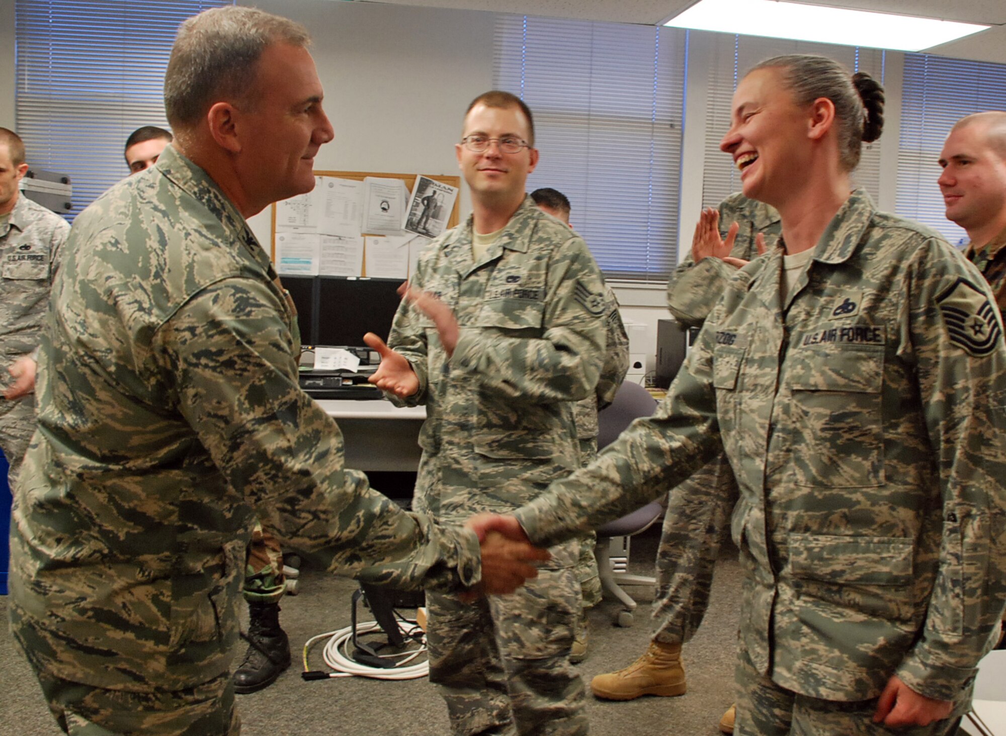 LAUGHLIN AIR FORCE BASE, Texas – Master Sgt. Linda Herzog, 47th Installation Support Squadron, communication operations flight superintendent, is surprised by Col. John Doucette, 47th Flying Training Wing commander, as he congratulate her here for winning  19th Air Force Senior NCO of the year recently. “There is no way that I could have won this award without the great people here in the 47th ISS and Laughlin in general,” said Sergeant Herzog, who competed against all senior NCOs in the 19th AF for the award. “They do wonderful work day in and day out and most of the credit should go to them.” (U.S. Air Force photo by Airman 1st Class Sara Csurilla)
