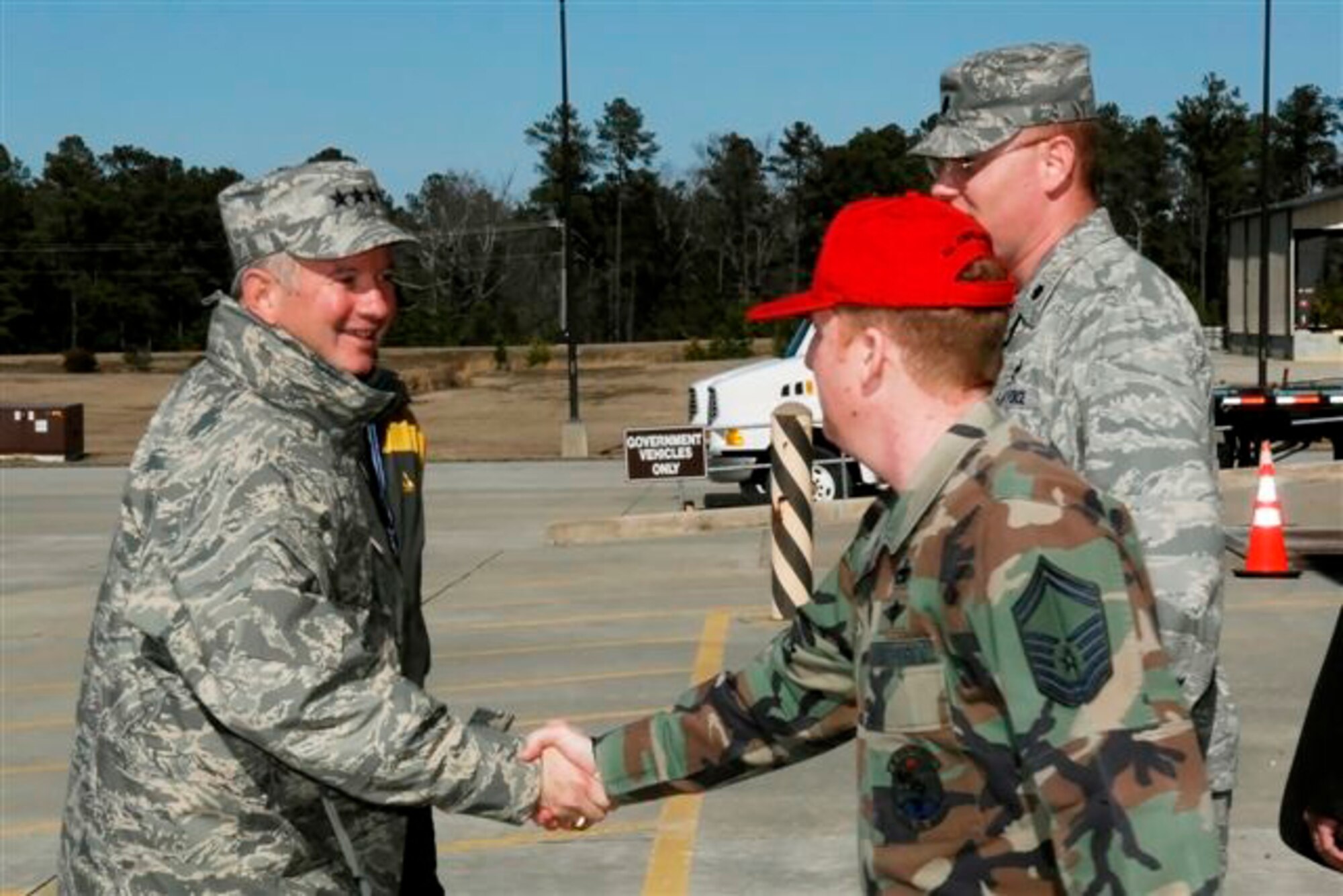 Gen. Duncan McNabb, U.S. Transportation Command Commander, shakes hands with Senior Master Sgt. Dave Salisbury, 3rd Aerial Port Squadron, during a visit to Pope Feb. 27. General McNabb visited Pope to have an up-close look at the most recent Joint Forcible Entry Exercise, which concluded March 6 and brought together units from throughout AMC, including 3rd APS, and Army units for joint airdrop and other mission training. (U.S. Air Force Photo by Mike Murchison)
