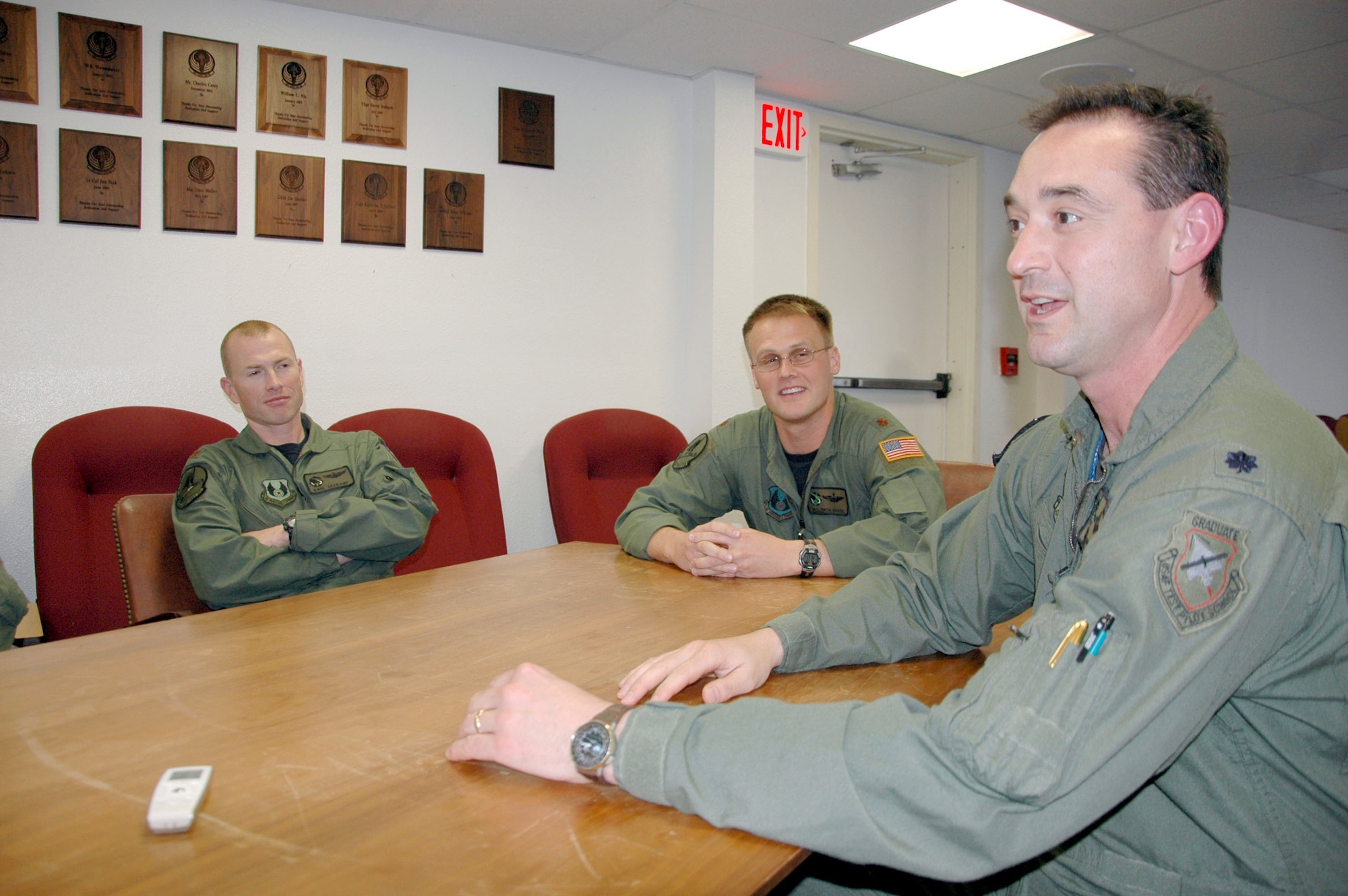 HURLBURT FIELD, Fla. - Test pilots Maj. Karl Seekamp and Maj. Solomon Baase listen to Lt. Col. Geno Wagner, commander of the 413th Flight Test Squadron, recently. The squadron, located at Hurlburt Field, flies special operations airframes, such as C-130 models and the CV-22 Osprey. (U.S. Air Force photo/Noel Getlin)