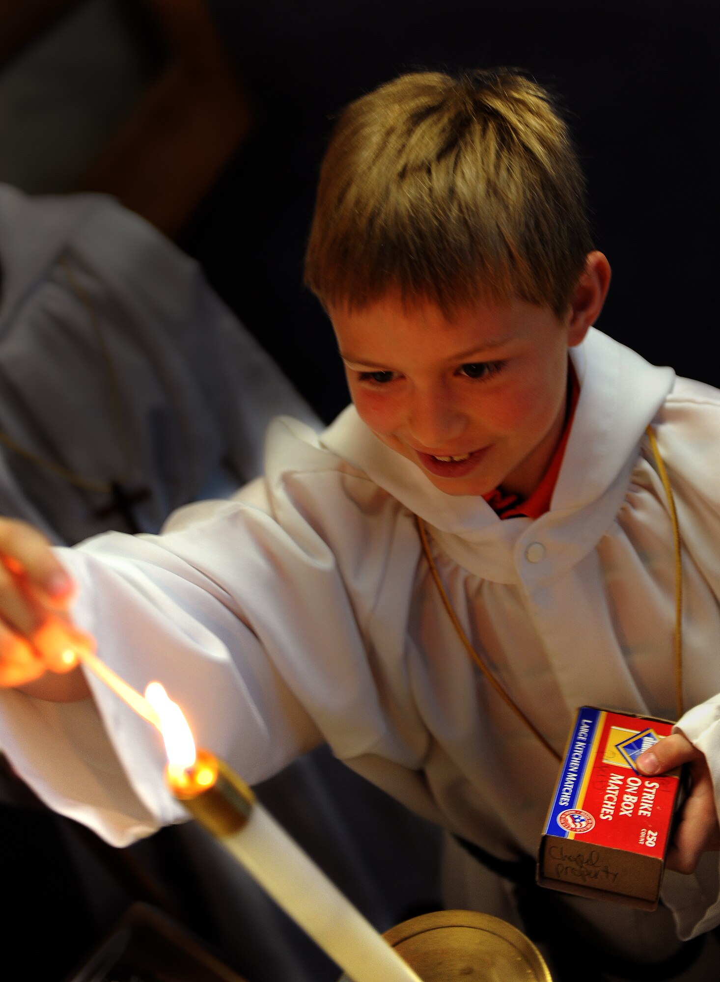 MOUNTAIN HOME AIR FORCE BASE, Idaho -- Bridger Beaty, an altar boy, lights a candle during Sunday morning mass at Liberty Chapel Feb. 22. The base chapel offers counseling as well as religious services to Gunfighters and their families. (U.S. Air Force photo/ Airman 1st Class Ashley Tank) 
