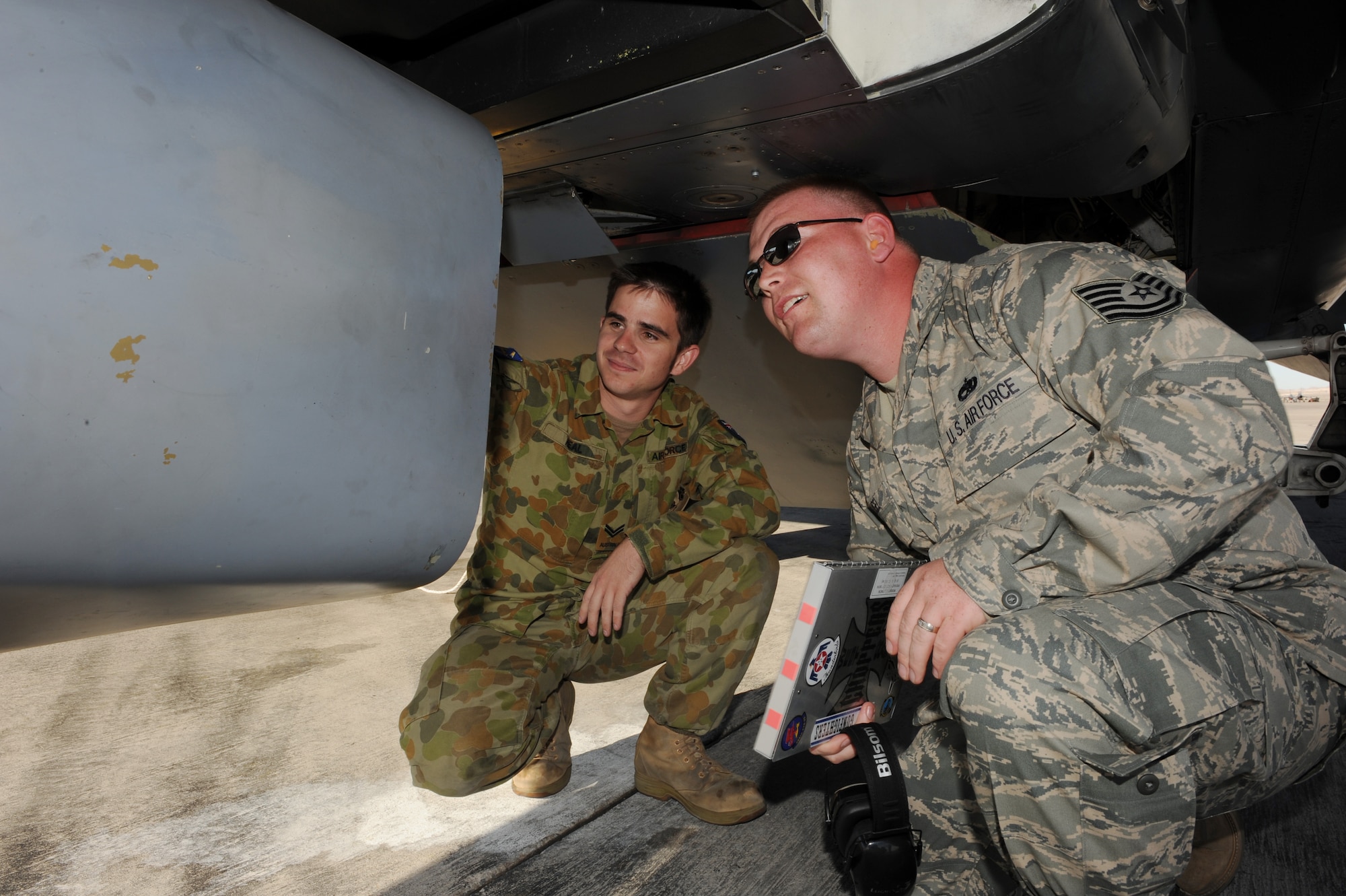 NELLIS AIR FORCE BASE, Nev. -- Tech. Sgt. Nathaniel Flugel, Red Flag Air Expeditionary Wing Quality Assurance from Mountain Home Air Force Base, Idaho, conducts a quality assessment of an F-111 while Royal Australian air force Cpl. Mark Heal looks on. QA serves as the primary technical advisory agency in the maintenance organization. Red Flag is a realistic combat training exercise involving the air forces of the United States and its allies. The exercise is conducted on the 15,000-square-mile Nevada Test and Training Range north of Las Vegas. (U.S. Air Force photo/ Senior Airman Samantha S. Crane)