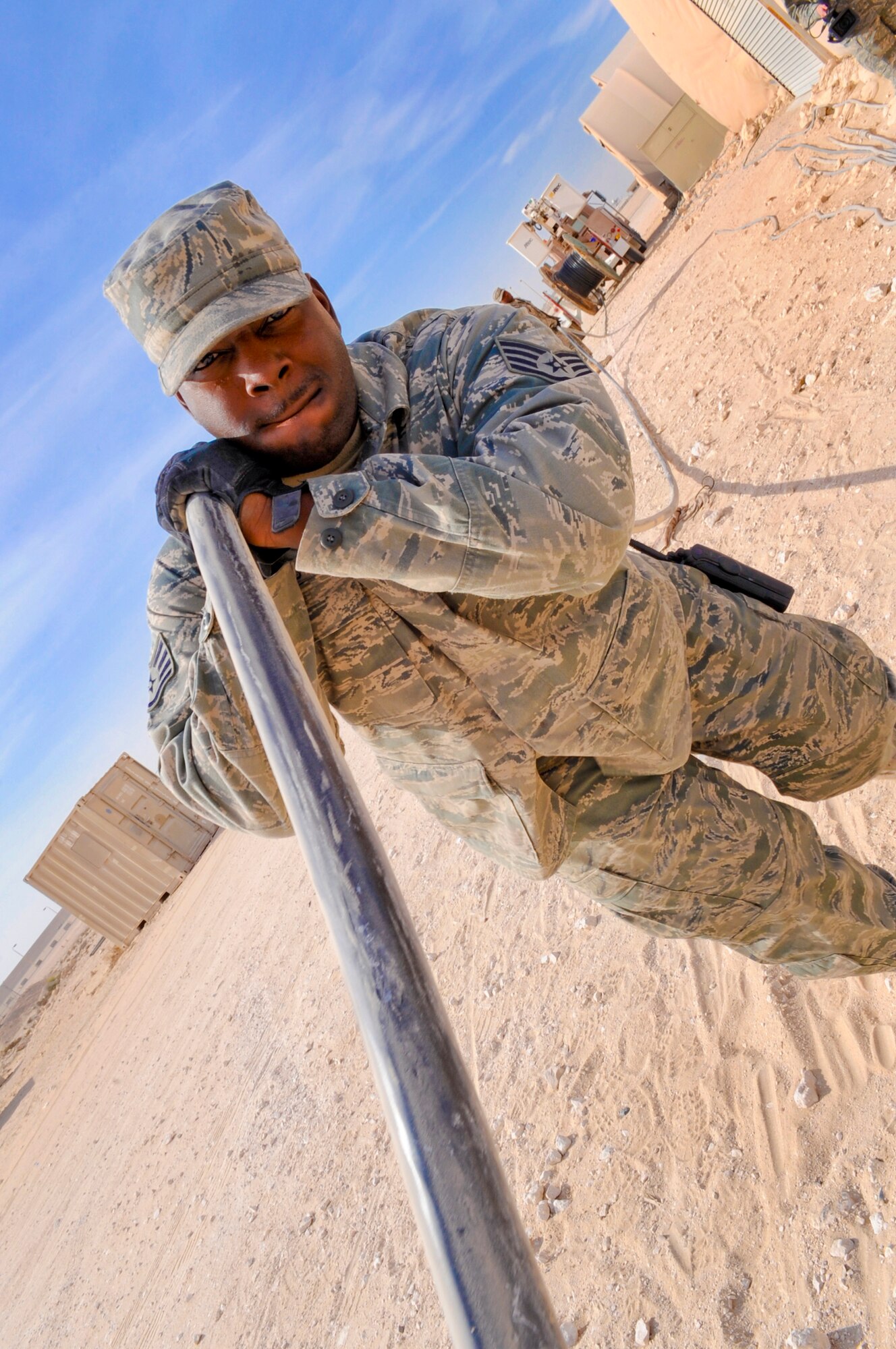 Staff Sgt. Jonathan Williams, an electrician with the 379th Expeditionary Civil Engineer Squadron, pulls high voltage cable to lay it out for an electrical project, March 9, 2009, in an undisclosed location in Southwest Asia.  The cable will be used to switch buildings from generators to commercial power. Sergeant Williams is native to Blytheville, Ark. and is deployed from Langley Air Force Base, Va., in support of Operations Iraqi and Enduring Freedom and Combined Joint Task Force - Horn of Africa.  (U.S. Air Force Photo by Staff Sgt. Joshua Garcia/released)