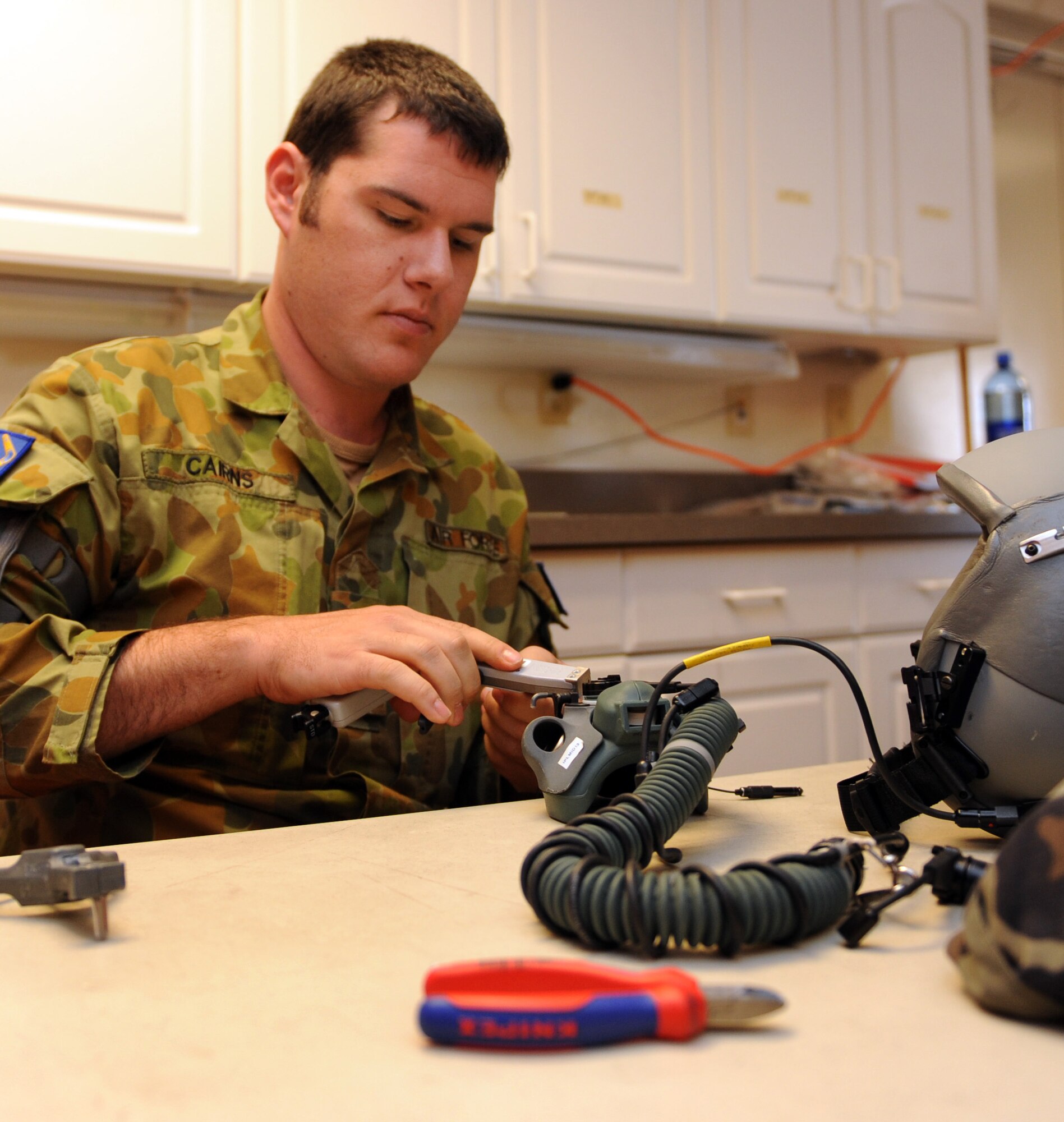 NELLIS AIR FORCE BASE, Nev. -- Leading Air Craftsman Chris Cains, Red Flag Air Expeditionary Wing aircrew flight equipment from the Royal Australian Air Force inspects an aircrew flight mask while participating in Red Flag 09-3 March 3. Throughout Red Flag, Aircrew Flight Equipment personnel conduct pre-flight and post-flight survival gear inspections. Red Flag is the U.S. Air Force’s air combat training exercise involving U.S. and allied air forces. The exercise is conducted on the 15,000-square-mile Nevada Test and Training Range north of Las Vegas. (U.S. Air Force photo/Airman 1st Class Debbie Lockhart)