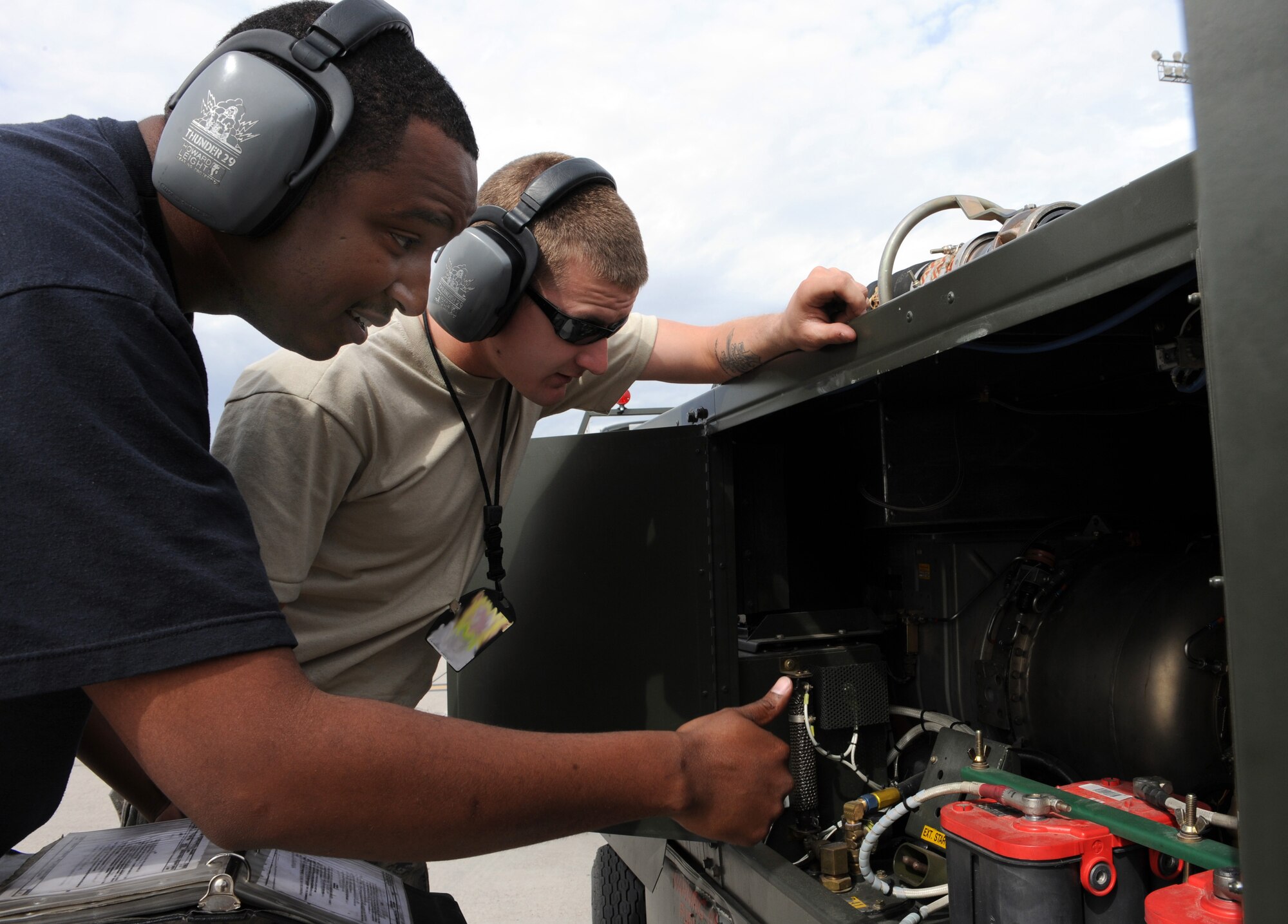 NELLIS AIR FORCE BASE, Nev. -- (Left) Staff Sgt. Kevin John, 23rd Equipment Maintenance Squadron journeyman from Moody Air Force Base, Ga., and Senior Airman Corey Roge, 1st EMS journeyman from Langley AFB, Va., perform a check on a generator while participating in Red Flag 09-3 March 2. Red Flag is the U.S. Air Force’s air combat training exercise involving U.S. and allied air forces. The exercise is conducted on the 15,000-square-mile Nevada Test and Training Range north of Las Vegas. (U.S. Air Force photo/Airman 1st Class Debbie Lockhart)