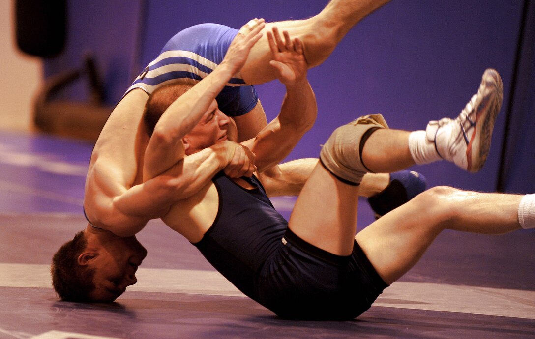 Airman 1st Class Tyler Moore wrestles Senior Airman Christopher Wise during a training match for the Air Force Wrestling Camp Feb. 25 at Mountain Home Air Force Base, Idaho. Airman Moore, a native of Nampa, Idaho, is one of 11 Airmen selected to represent the Air Force during the Armed Forces Wrestling Championships hosted at Mountain Home AFB. Training for the service-wide competition begins here March 7. Airman Moore is from Aviano Air Base, Italy, and Airman Wise is stationed at Moody AFB, Ga. (U.S. Air Force photo/Senior Airman Ryan Crane) 