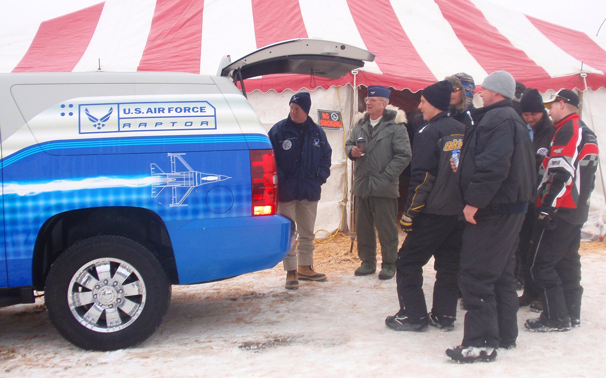 Race fans gather around the 339th Recruiting Squadron's Raptor at the International 500 Snowmobile Race Feb. 7 in Sault St. Marie, Mich. The Raptor is a three-piece mobile marketing tool that promotes the Air Force recruiting campaign and collects data from people interested in Air Force job opportunities. (Courtesy photo) 