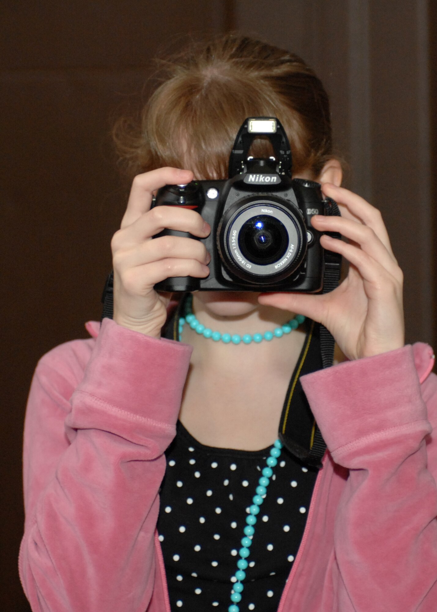 SPANGDAHLEM AIR BASE, Germany – Elizabeth Buchholz, a Bitburg Middle School student, learns about photography during Job Shadow Day March 2, 2009. Elizabeth is the daughter of Libby Bennett and Tech. Sgt. Tommy Buchholz, formerly of the 52nd Force Support Squadron. (Courtesy photo)