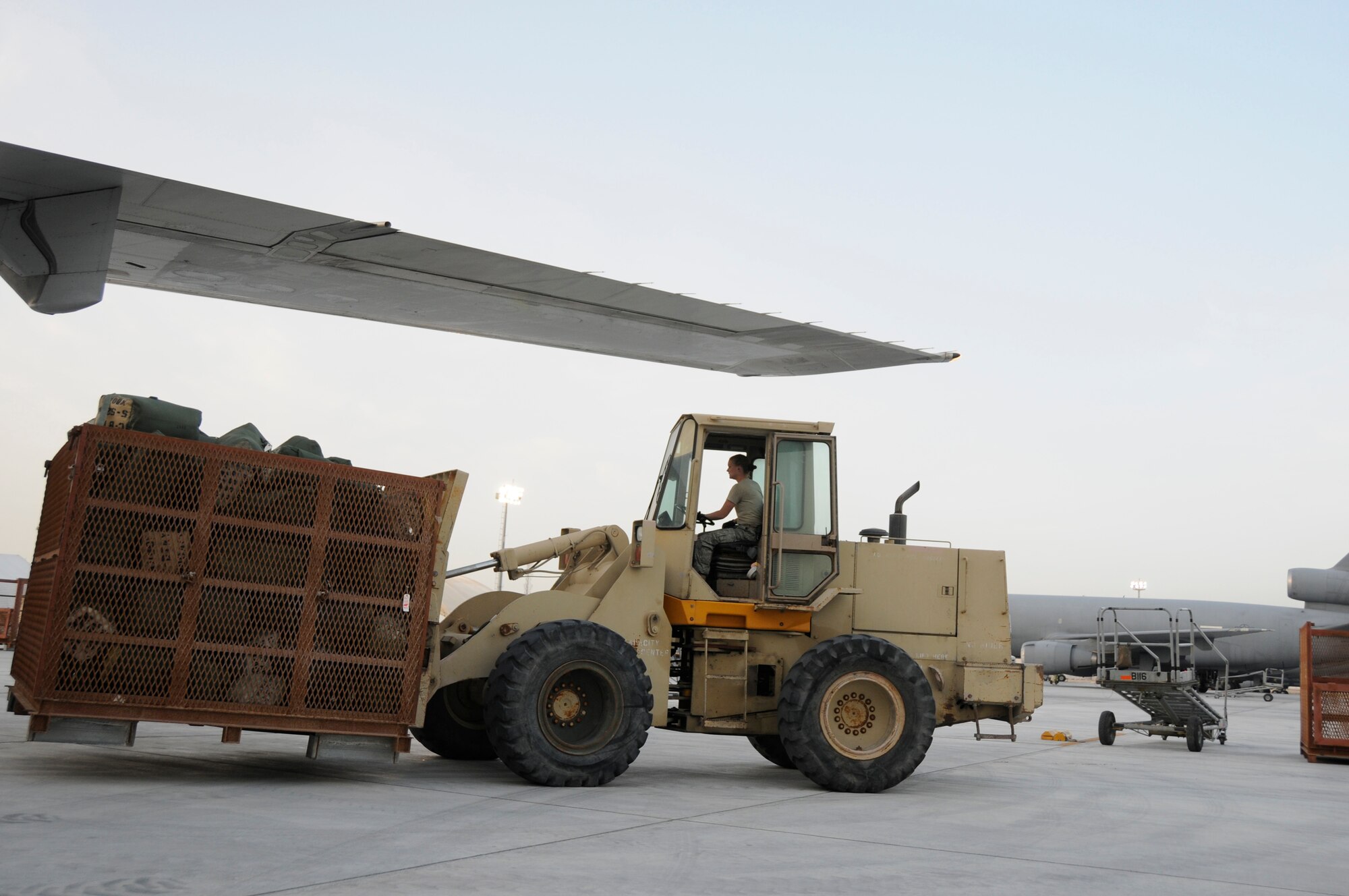 SOUTHWEST ASIA - Duffle bags and luggage belonging to the 5-52 Air Defense Artillery Battalion is off-loaded from a DC-10 commercial airline at the 380th Air Expeditionary Wing, Mar 5. 200 Soldiers and several C-5 Galaxy's loaded with vehicles and equipment landed throughout the last few days as part of the first Patriot Battery mission for the wing, improving air defense capability. The Army will be incorporated into the 380th AEW's mission in support of Operations Iraqi and Enduring Freedom and Joint Task Force Horn of Africa. The 5-52 Air Defense Artillery Battalion is deployed out of Fort Bliss, TX. (U.S. Air Force photo by Senior Airman Brian J. Ellis)