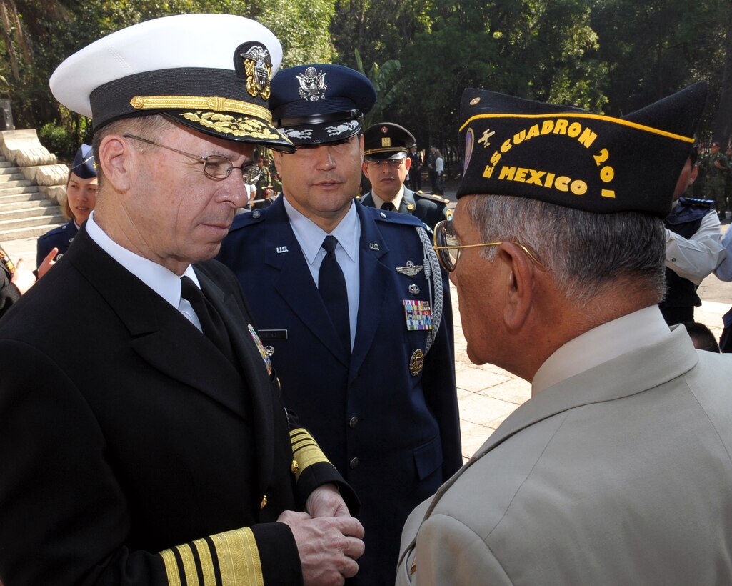 U.S. Navy Adm. Mike Mullen, chairman of the Joint Chiefs of Staff, talks to a former 201st Fighter Squadron member at Chapultepec Park in Mexico City, Mexico, March 6, 2009.