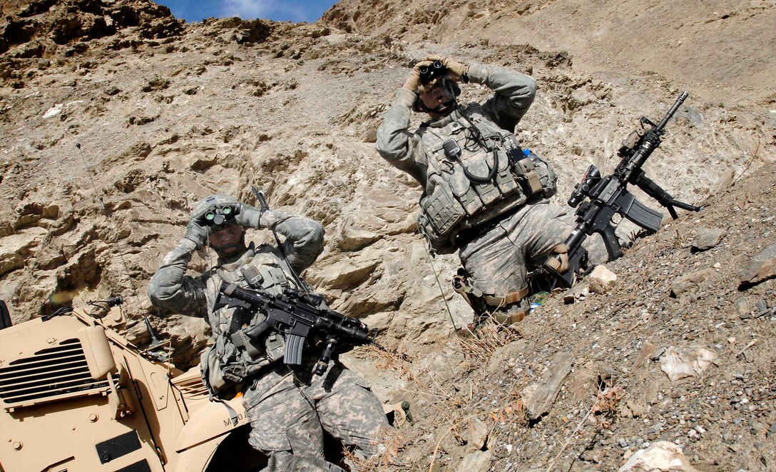 U.S. Army Lt. Col. Kimo Gallahue and Command Sgt. Maj. Andy Spano watch clearing operations in the Tangi Valley in Wardak province, Afghanistan, March 7, 2009. Gallahue and Spano are assigned to the 10th Mountain Division's 2nd Battalion, 87th Infantry Regiment, 3rd Brigade Combat Team. The battalion pushed to clear the area that has seen few coalition forces in the past year.
