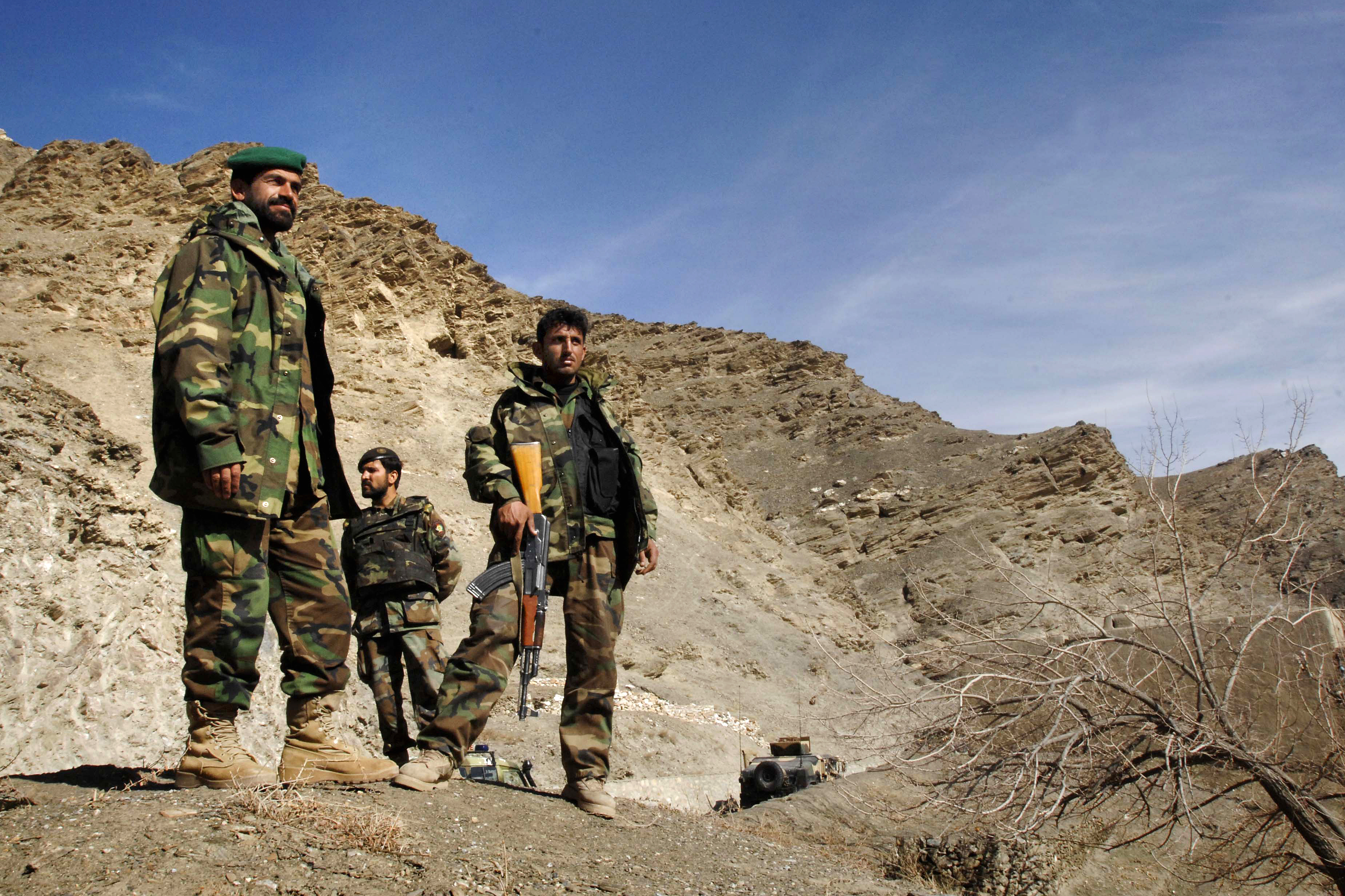 Members Of The Afghan National Army Stand On A Ridge And Watch Clearing Operations Below In