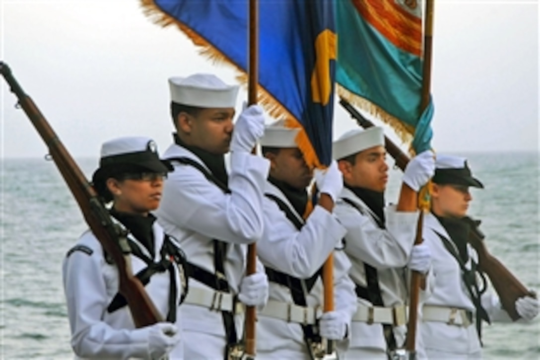 The U.S. Navy color guard aboard USS Theodore Roosevelt parades the colors during a burial at sea in the Gulf of Oman, March 5, 2009. The aircraft carrier is operating in the U.S. 5th Fleet area of responsibility.