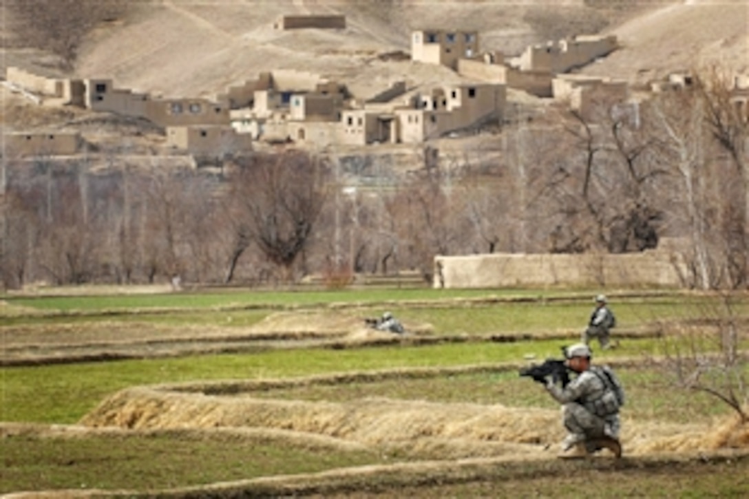 U.S. Army soldiers walk through a field outside a village in the Tangi Valley, Wardak province, March 8, 2009. The soldiers are assigned to the 10th Mountain Division's 3rd Brigade Combat Team. The Tangi Valley is a fertile bread-basket in this region. Snow and rain runs off the mountains into a valley of apple and pomegranate orchards. It is also a hotbed for insurgent activity.