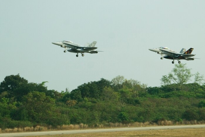 Two Marine Fighter Attack Squadron (All-Weather) 224 F/A-18D Hornets take to the skies during exercise Cope Tiger 2009 at Korat Royal Thai Air Force Base, Thailand. Cope Tiger is an annual multilateral joint and combined field training exercise conducted to improve U.S., Thai and Singapore readiness and interoperability.