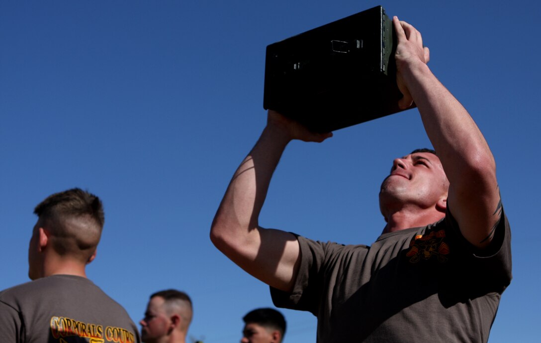 Cpl. William Wolf, a Corporals Course student from Marine Wing Support Squadron 374, executes an ‘ammo-can lift,’ one of the exercises in the Combat Fitness Test that the Marines in the course participated in March 10.
