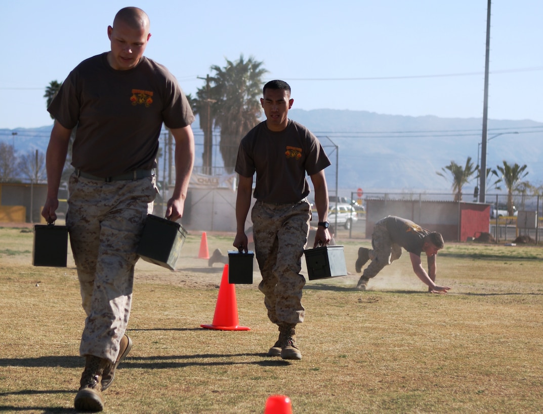 Two Corporals Course students manipulate the zig-zag cones during the ‘maneuver under fire’ portion of the Combat Fitness Test that the Marines in the course participated in March 10.