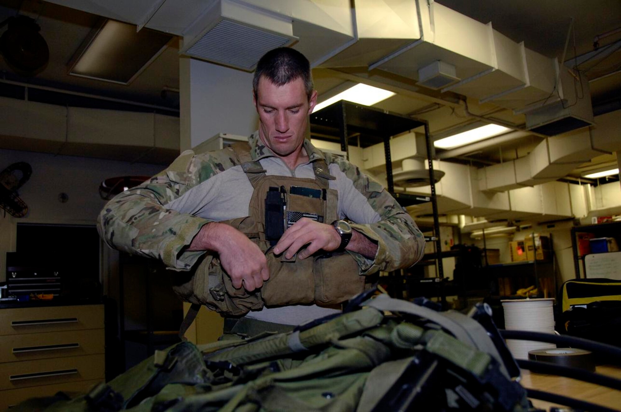 Tech. Sgt. Sean Kirsch, 131st Rescue Squadron pararescueman, Moffett Federal Airfield, California Air National Guard, dons his tactical gear for a routine training mission March 10. Sergeant Kirsch used his specialized life saving skills to assist an accident victim near Suisun, Calif., March 9. (U.S. Air Force photo by Tech. Sgt. Ray Aquino)
