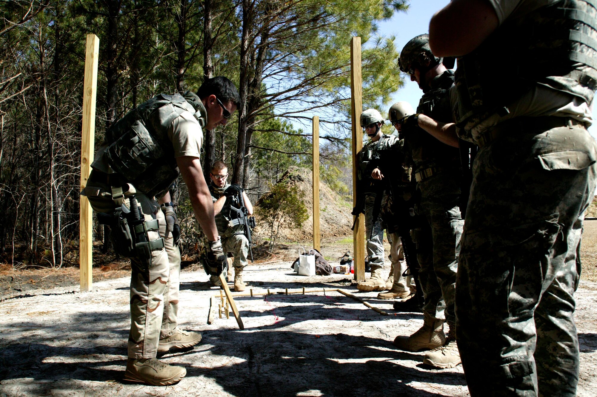 ORANGEBURG, S.C.-- Airman 1st Class Cooper Gibson, an explosive ordnance disposal technician from Seymour Johnson Air Force Base, N.C., reviews a convoy operation plan with teammates during the Tactical Survival Advanced Course March 5. (U.S. Air Force photo/Staff Sgt. Holly Brown)