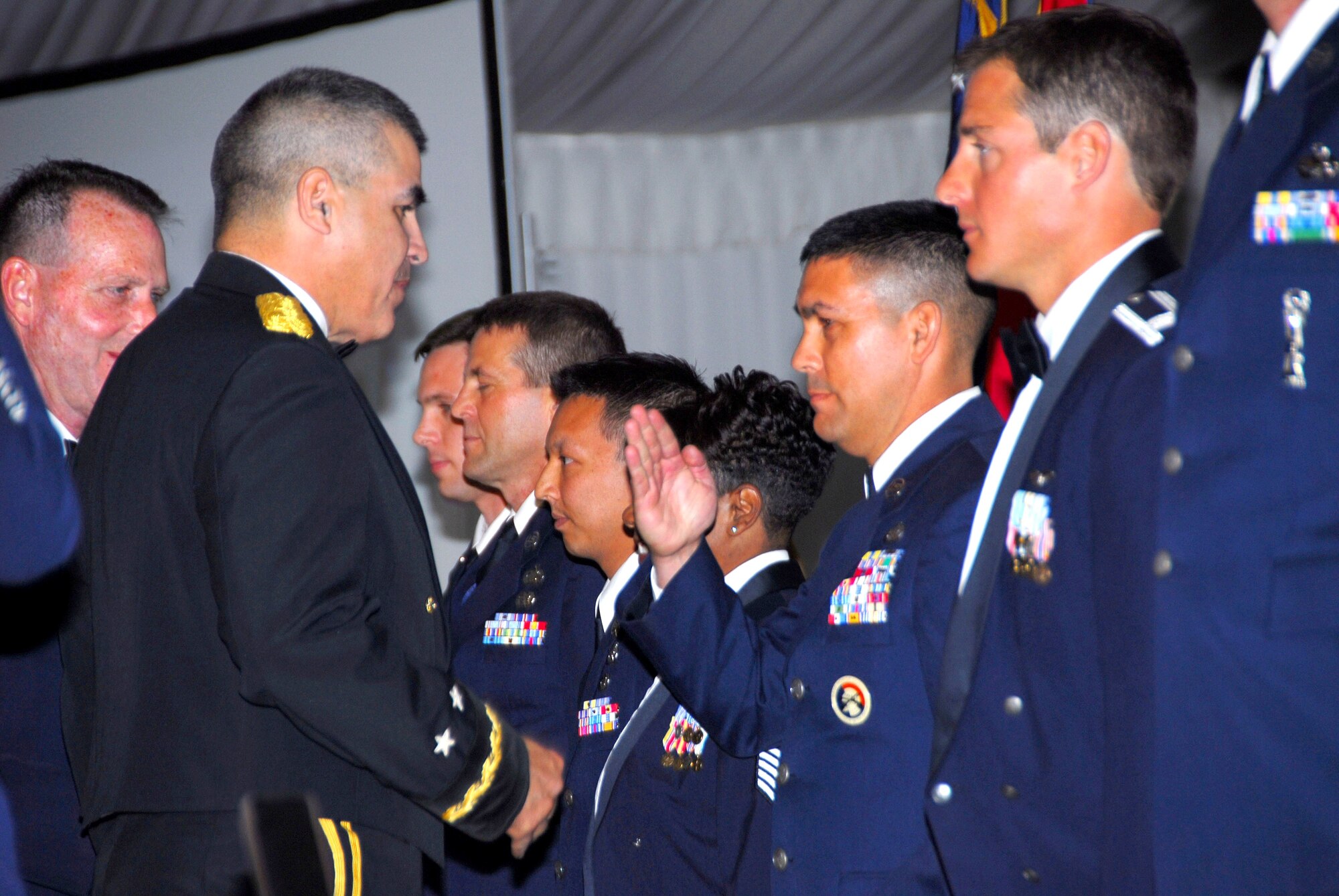 Tech. Sgt. Michael Brizuela, Outstanding Honor Guard Member of the Year from the 162nd Fighter Wing, salutes Maj. Gen. Hugo Salazar, Arizona Adjutant General at the Arizona Air National Guard’s Outstanding Airman of the Year banquet March 7.  (Air National Guard photo by Staff Sgt. Sarah Elliott)