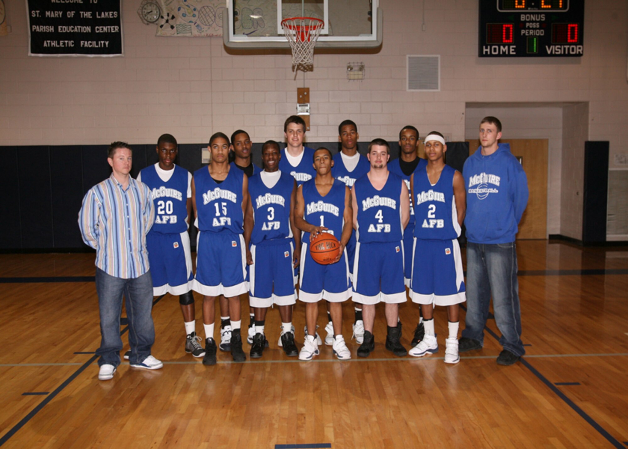 Members of the McGuire Falcons, run by the 87th Services Squadron Youth Programs, and Kevin Hansen (far left), the team’s coach, pose before the New Jersey State Semi-final game for high school March 7. The team won the game against St. Mary’s of the Lakes of Medford, N.J., 54-52, and claimed the state title. (Courtesy photo) 