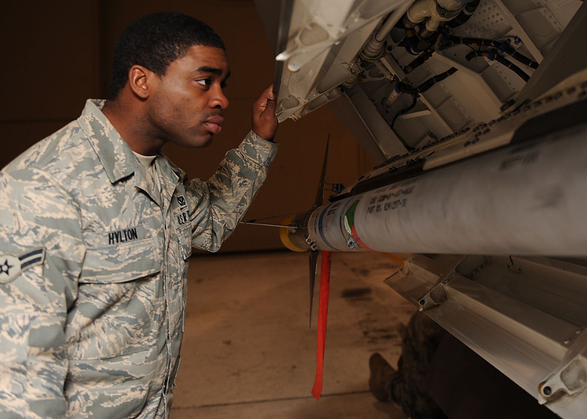 Airman 1st Class Derrick Hylton, 49th Material Maintenance Squadron, takes a closer look at the F-22A Raptor during the F-22A Familiarization Course at Holloman Air Force Base, N.M. in December. The course, which is taught monthly, provides the base populace a chance to see the Raptor up close. (U.S. Air Force photo/Senior Airman John D. Strong)
