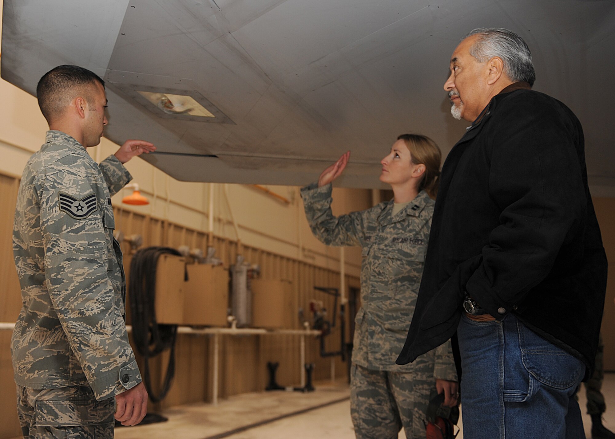 Staff Sgt. Fredereck Maurath, 49th Maintenance Operations Squadron, discusses the Air Force's most advanced aircraft with two people who attended the F-22A Familiarization Course at Holloman Air Force Base, N.M. last year. The two-hour course is taught monthly to both civilian and military personnel assigned to the base to better educate them on the fifth generation fighter.  (U.S. Air Force photo/Senior Airman John D. Strong)
