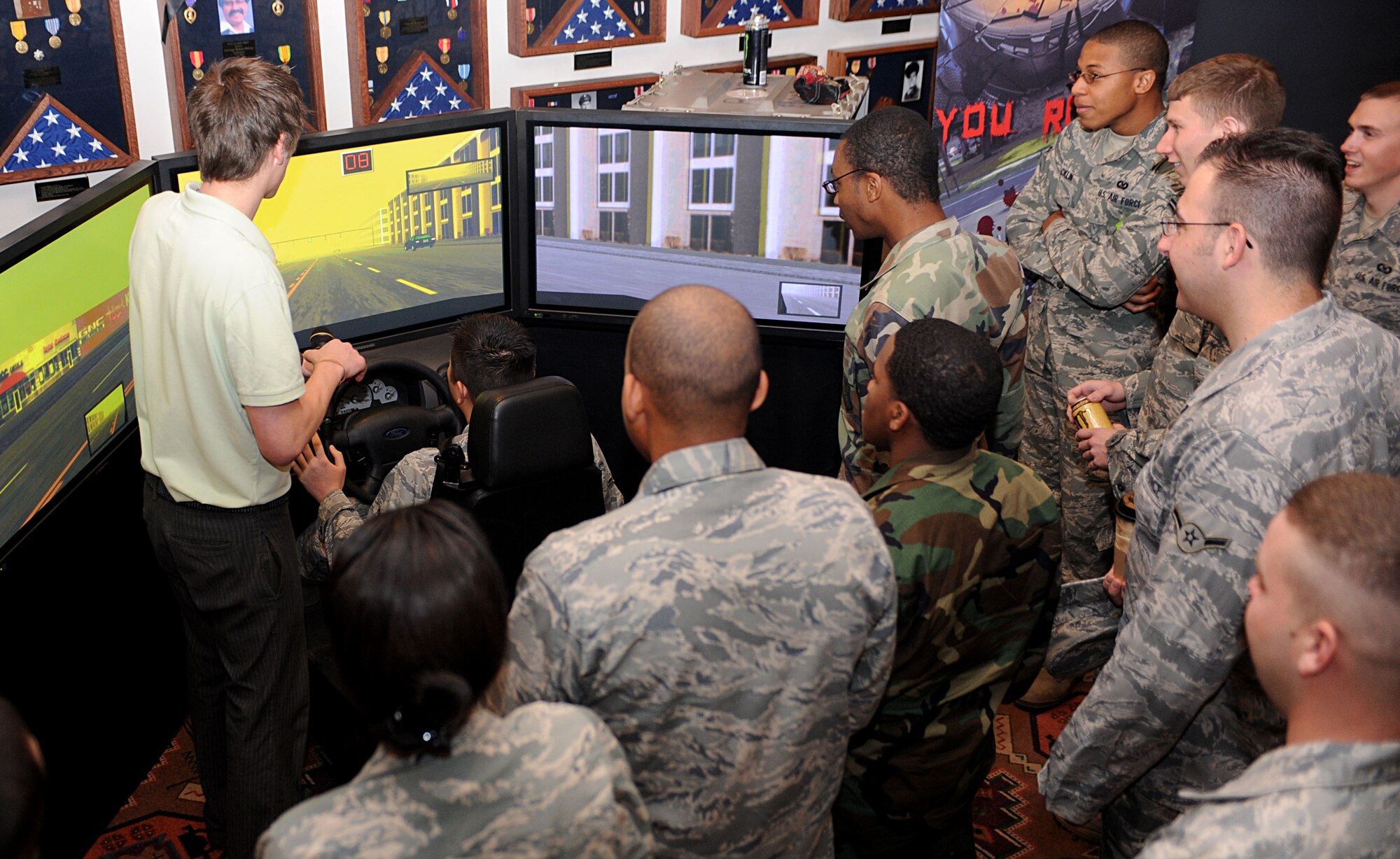 CANNON AIR FORCE BASE, N.M. -- Airmen gather around the drunk driving simulator during the national Save a Life Tour at The Landing March 10. The simulator allowed Airmen to experience the effects of driving under the influence of alcohol. This is the second consecutive year Cannon has hosted the event. (U.S. Air Force photo/Airman 1st Class Evelyn Chavez)